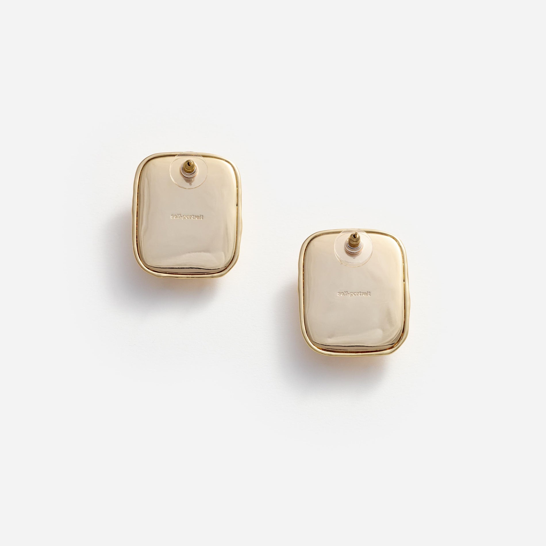 Side view of a woman wearing the Mottled Gold Black Earrings