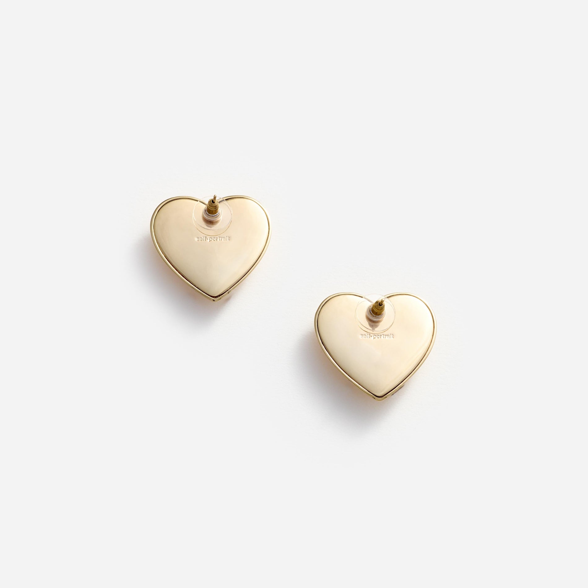 Side view of a woman wearing the Gold Crystal Heart Earrings
