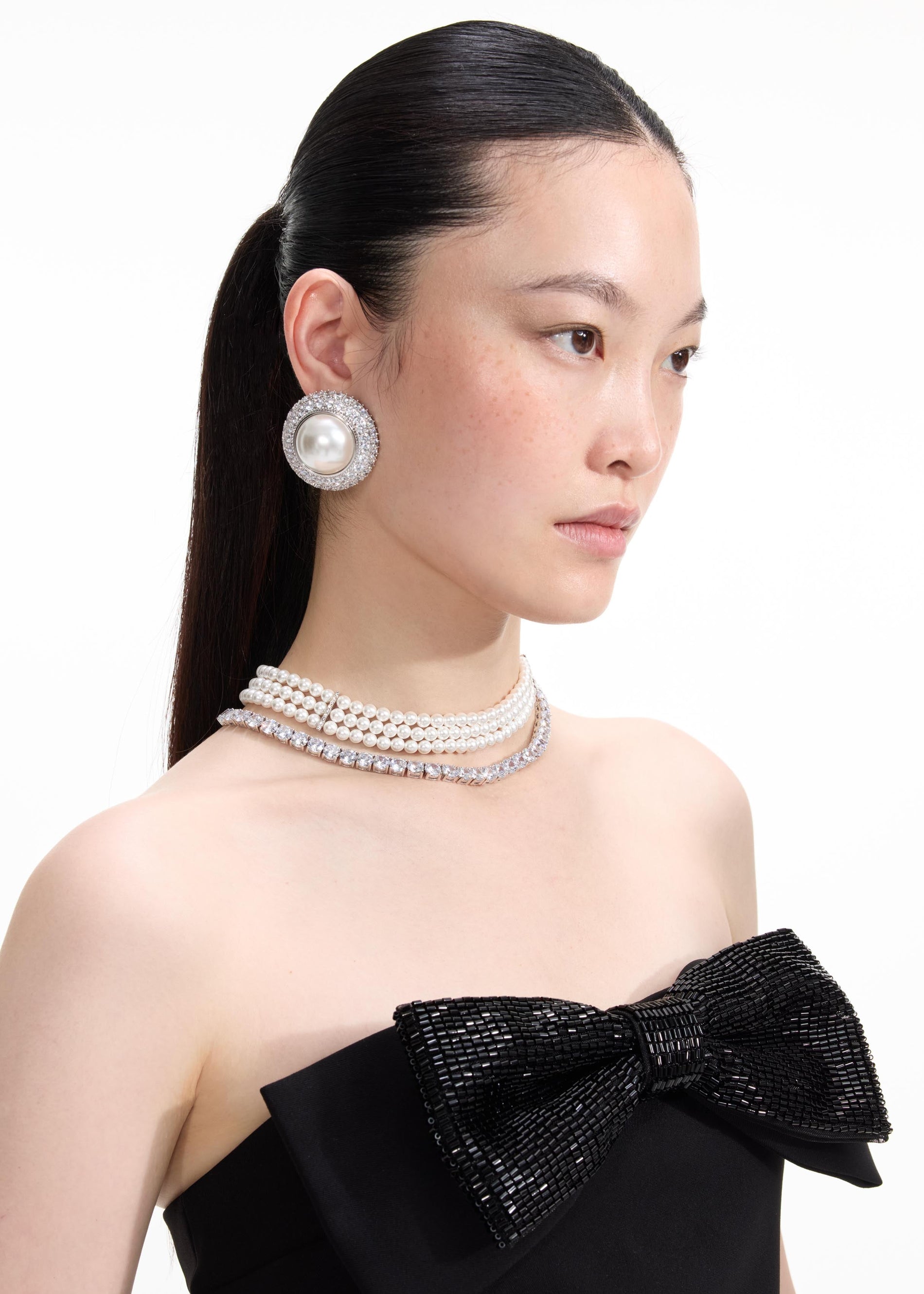 Back view of a woman wearing the Crystal Pearl Earrings