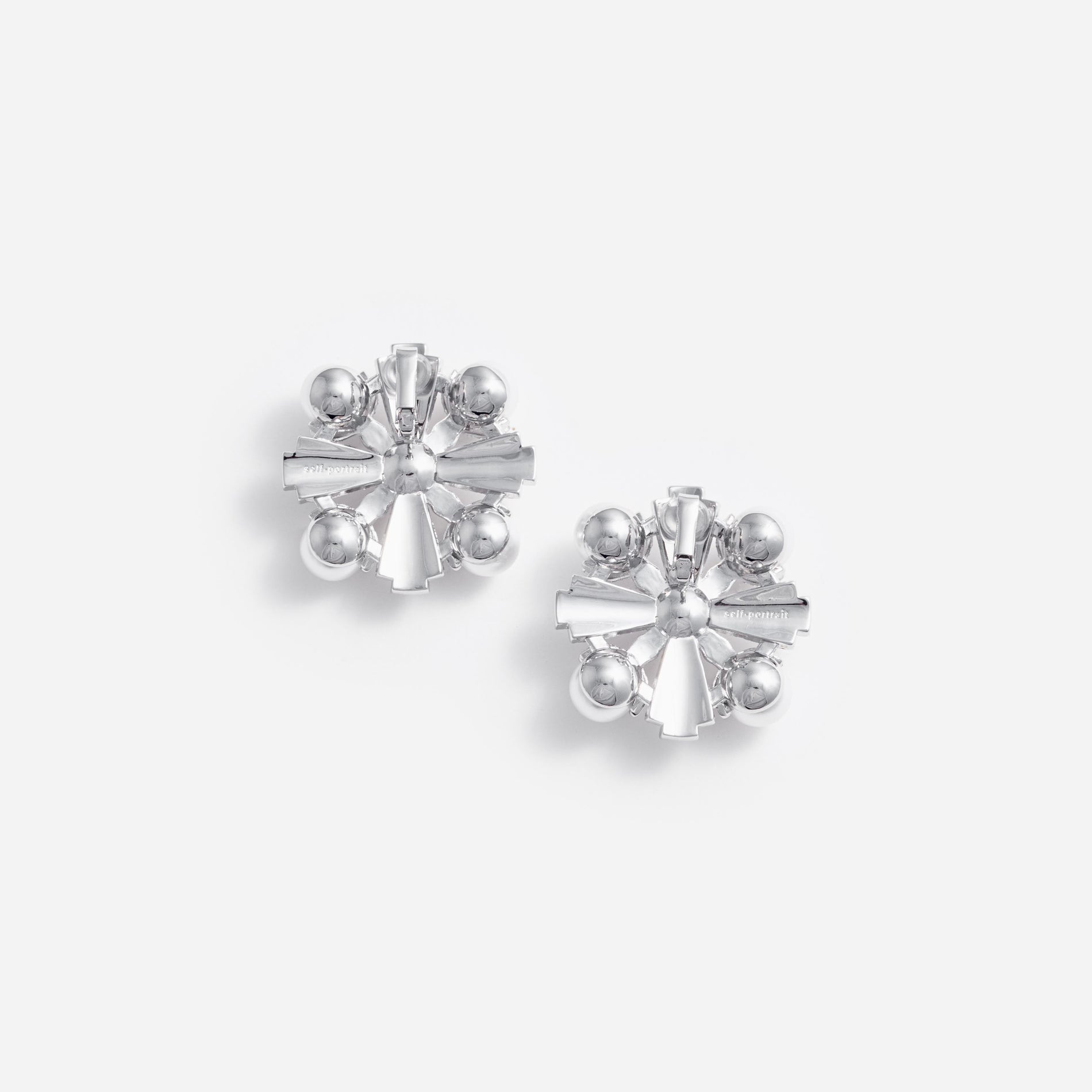 Side view of a woman wearing the Large Silver Encrusted Earrings