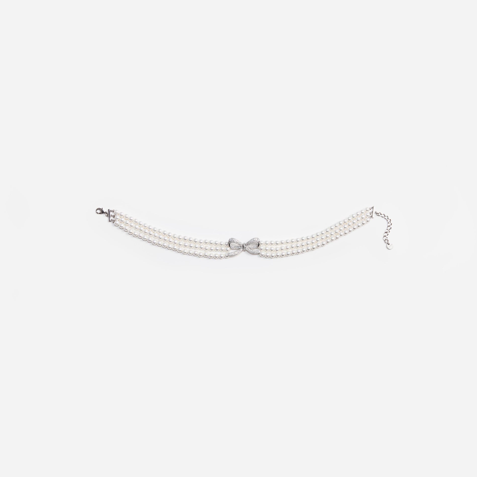 Side view of a woman wearing the Pearl Bow Choker