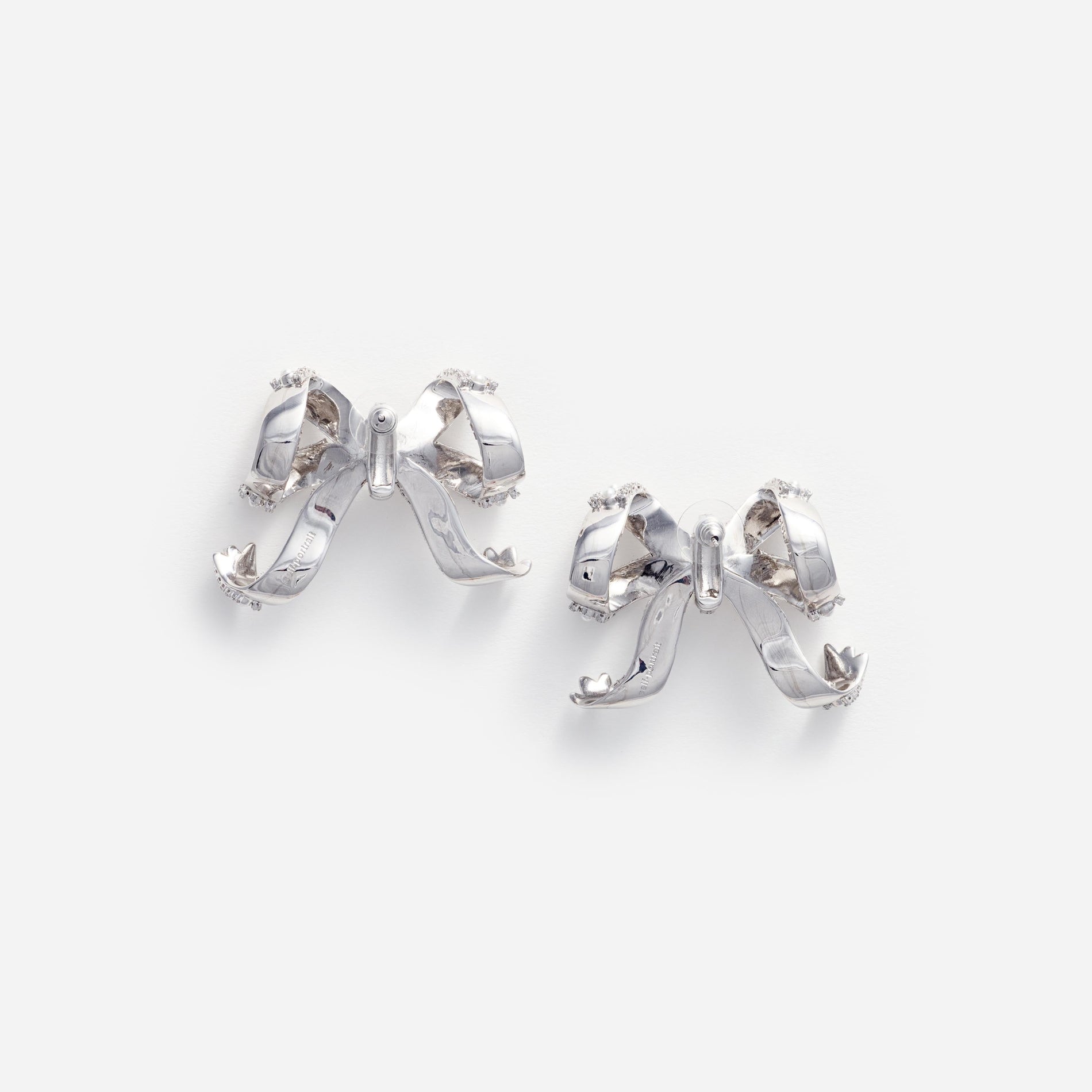 Side view of a woman wearing the Pearl Crystal Bow Earrings