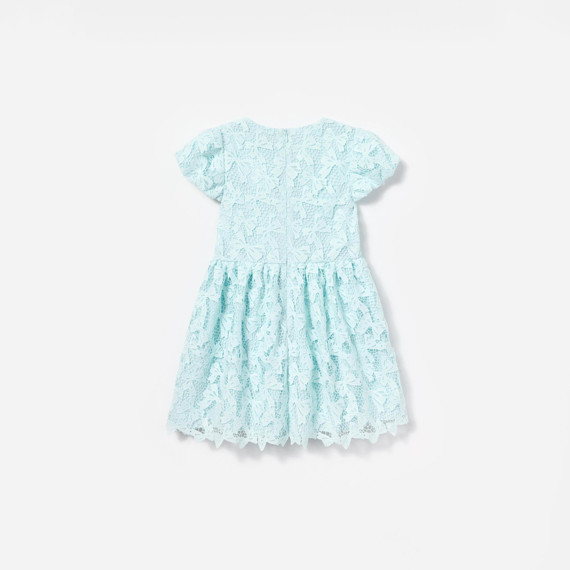 Side view of a woman wearing the Blue Bow Lace Dress