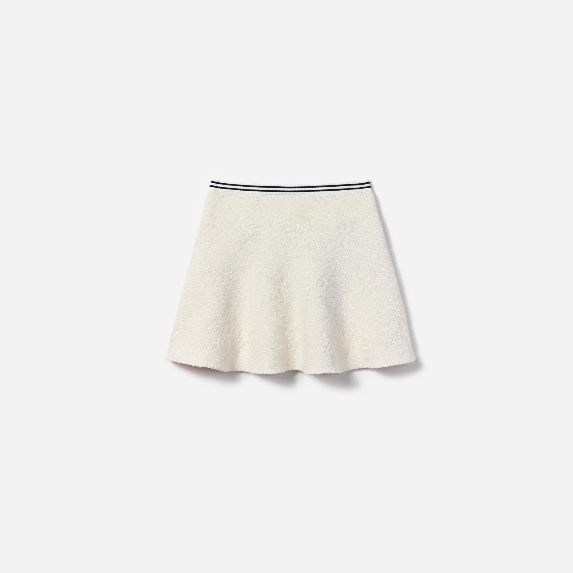 Side view of a woman wearing the White Jacquard Knit Skirt