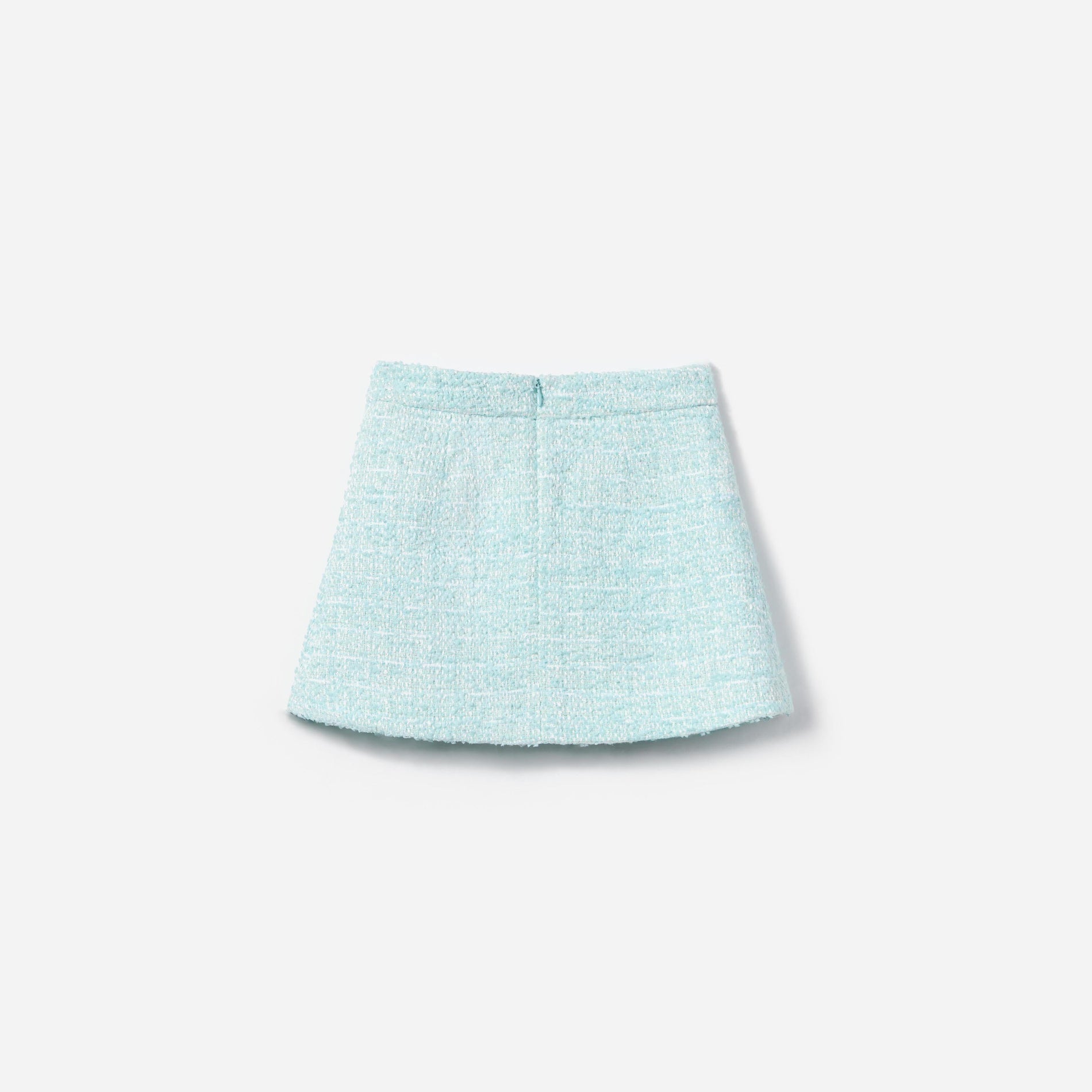 Side view of a woman wearing the Blue Boucle Skirt