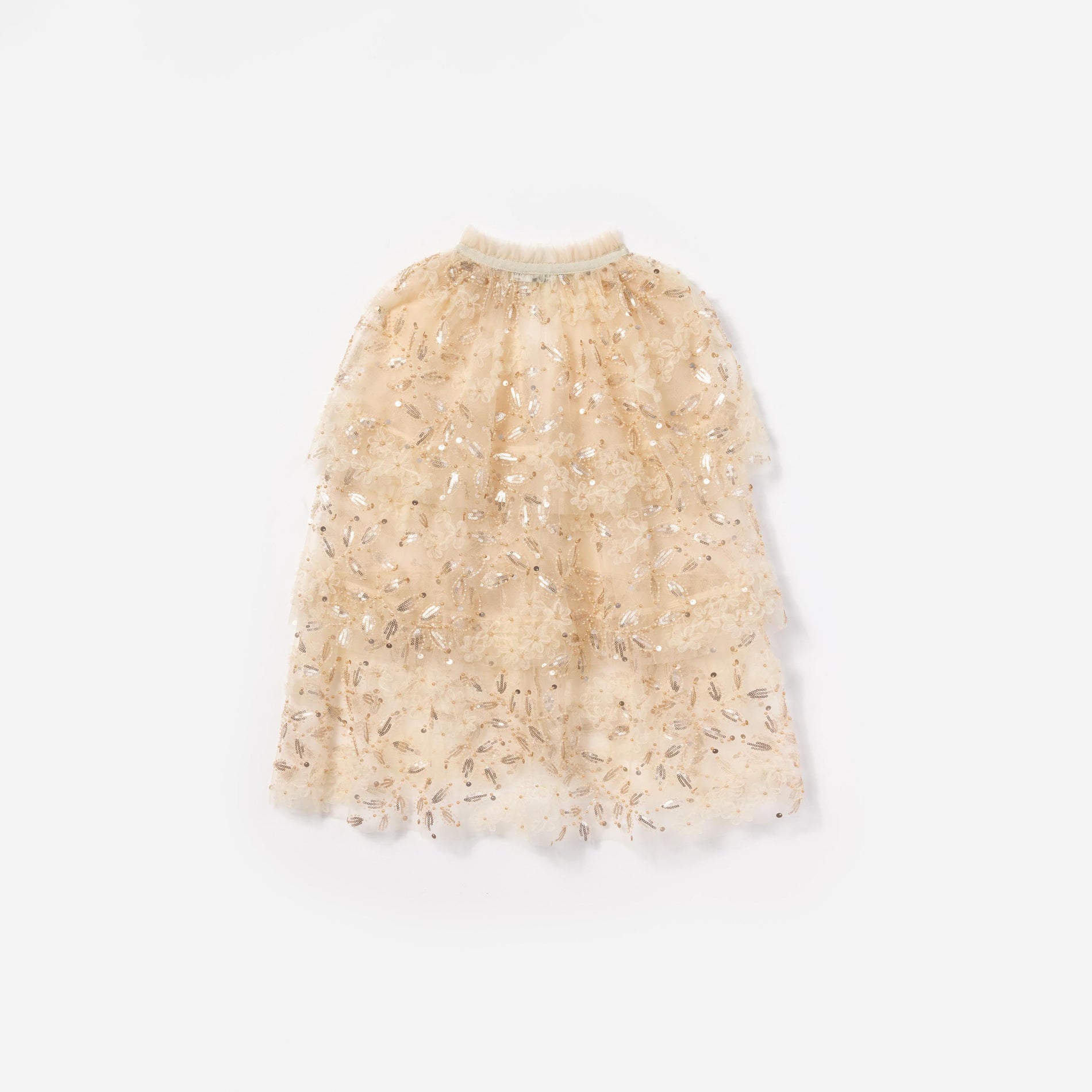 Side view of a woman wearing the Cream Sequin Tulle Cape