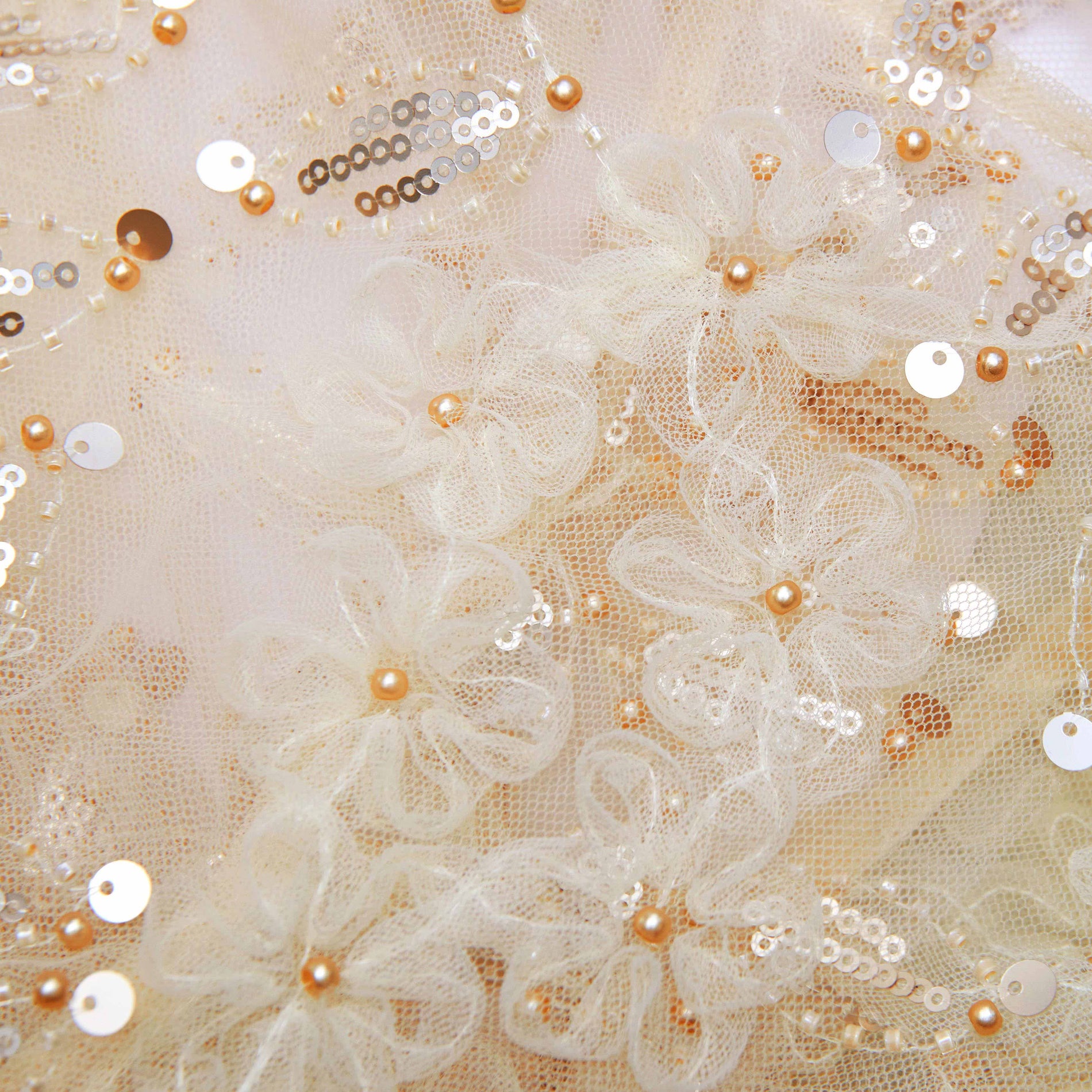 Back view of a woman wearing the Cream Sequin Tulle Cape