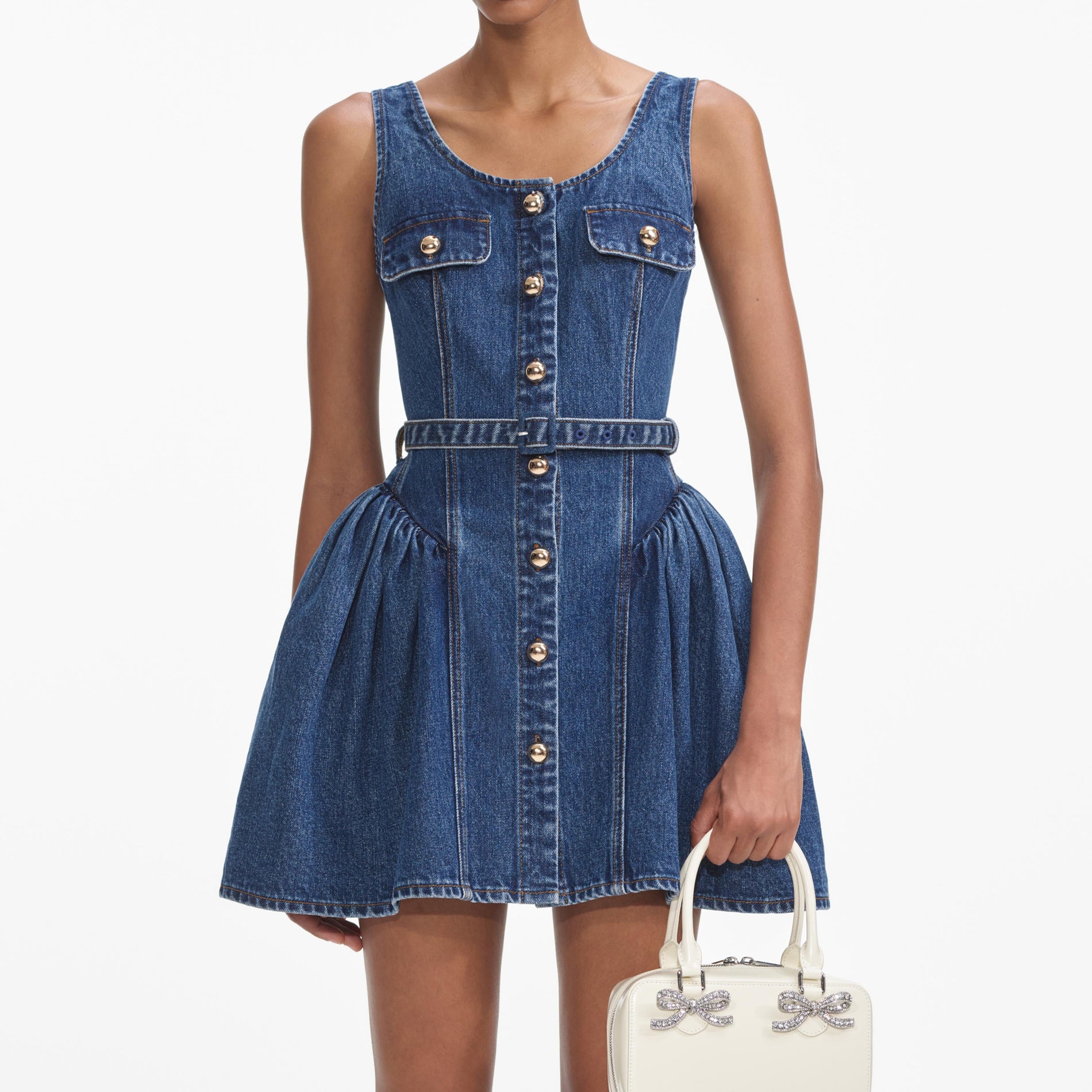 A close up of a woman wearing the Flared Denim Mini Dress