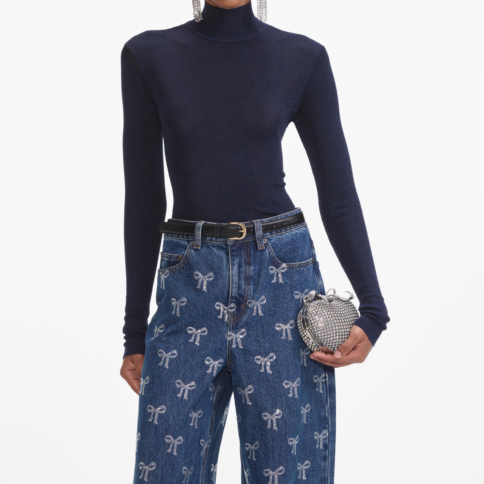 A close up of a woman wearing the Rhinestone Bow Denim Jeans