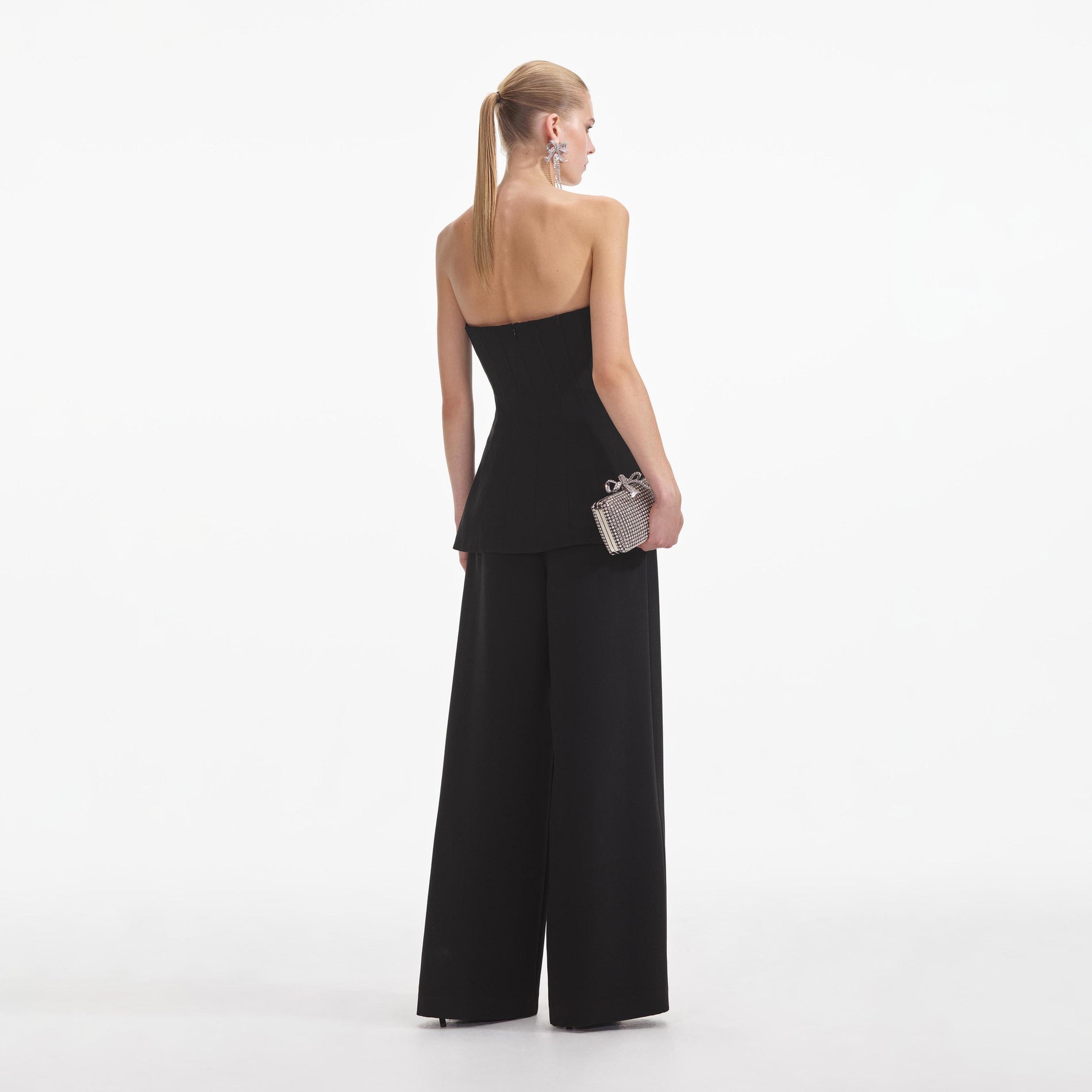 Back view of a woman wearing the Black Bandeau Crepe Jumpsuit