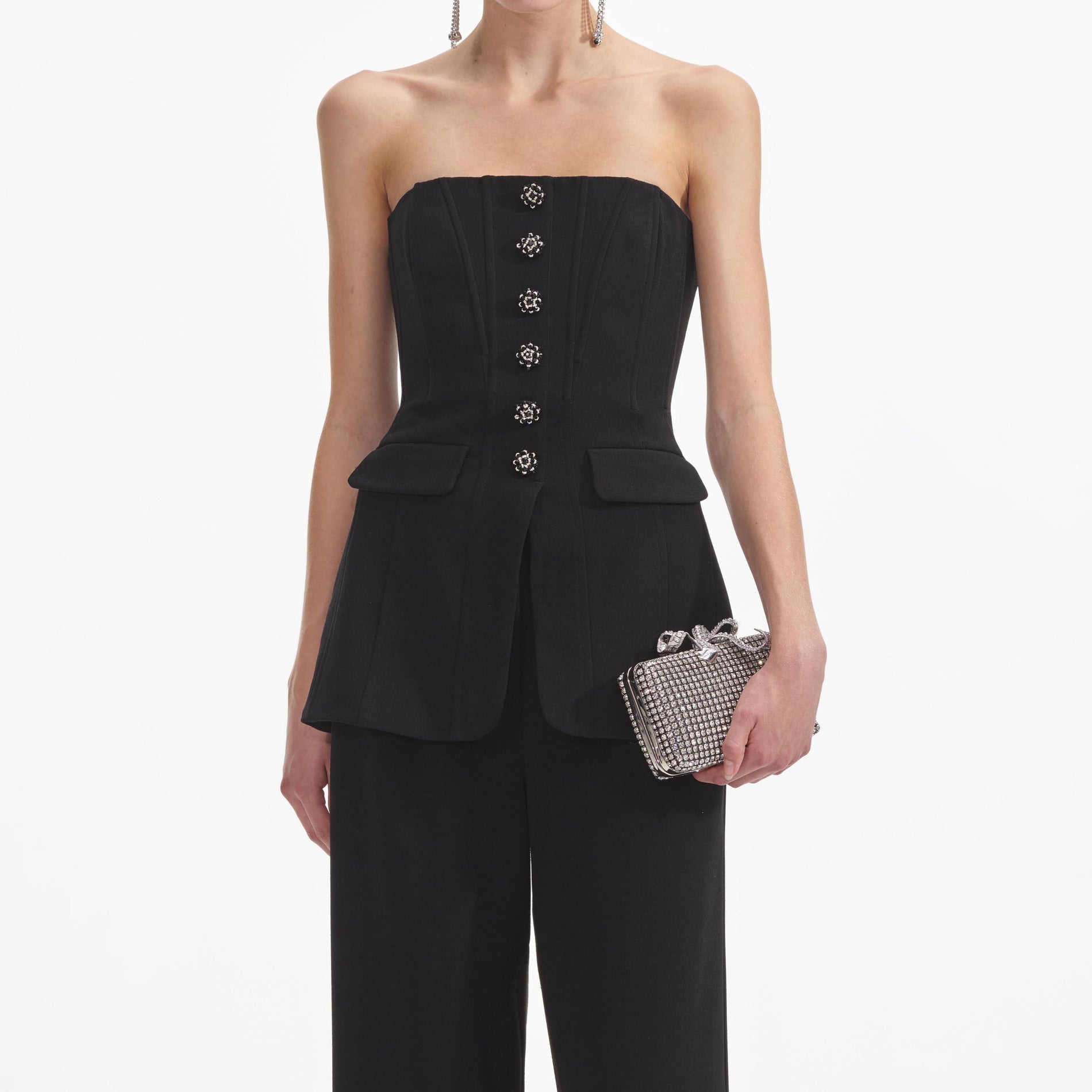 A close up of a woman wearing the Black Bandeau Crepe Jumpsuit
