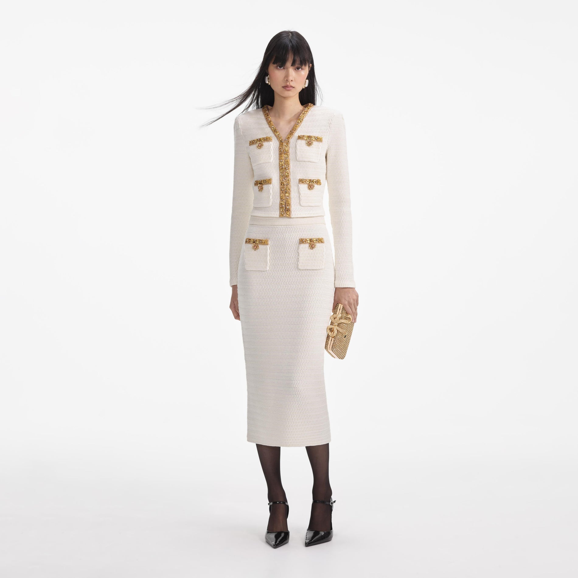 Front view of a woman wearing the Cream Lurex Knit Midi Skirt