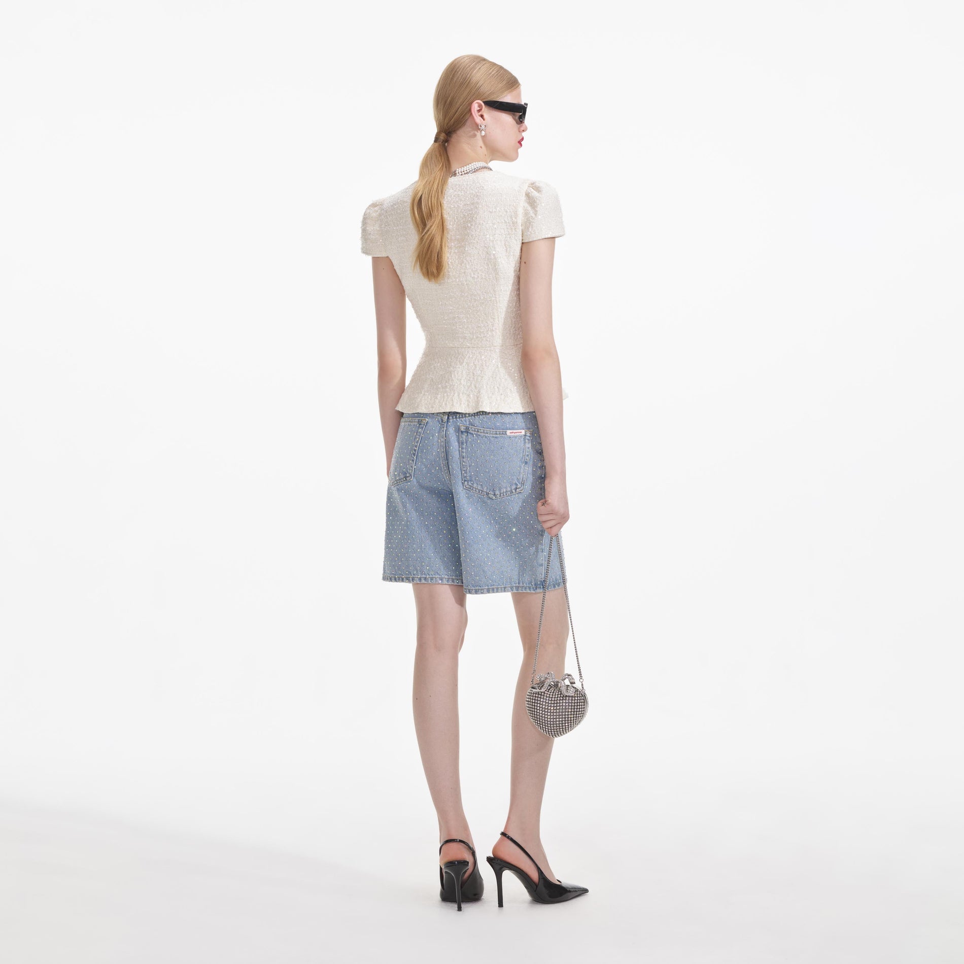 A close up of a woman wearing the Cream Boucle Bow Detail Top
