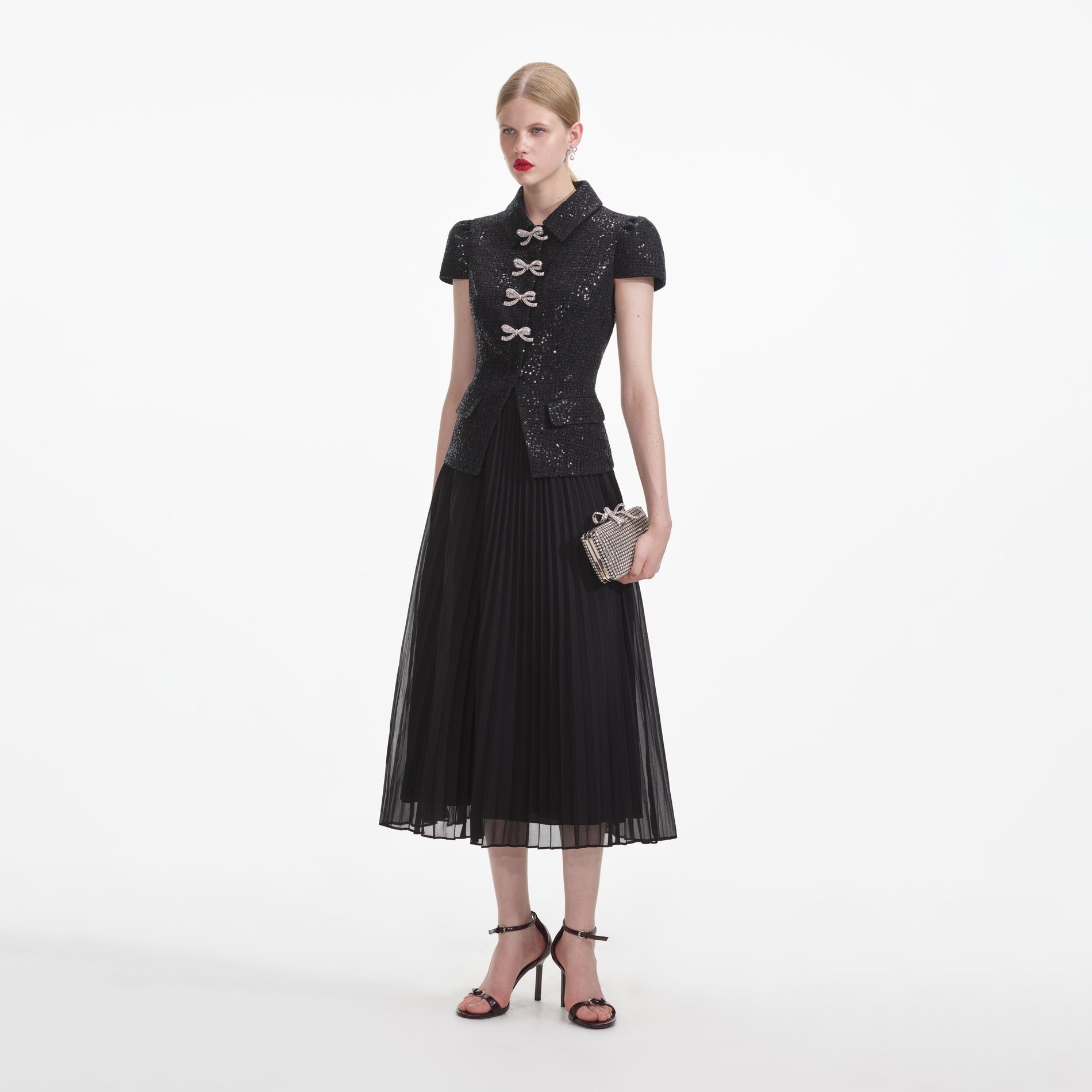 Side view of a woman wearing the Black Boucle Bow Midi Dress