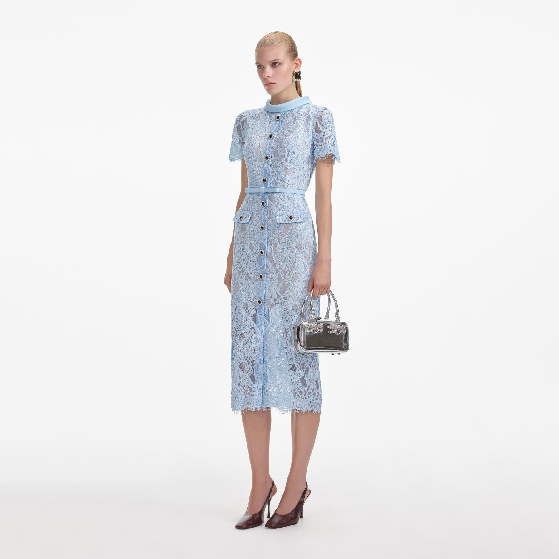 Side view of a woman wearing the Blue Lace Button Midi Dress