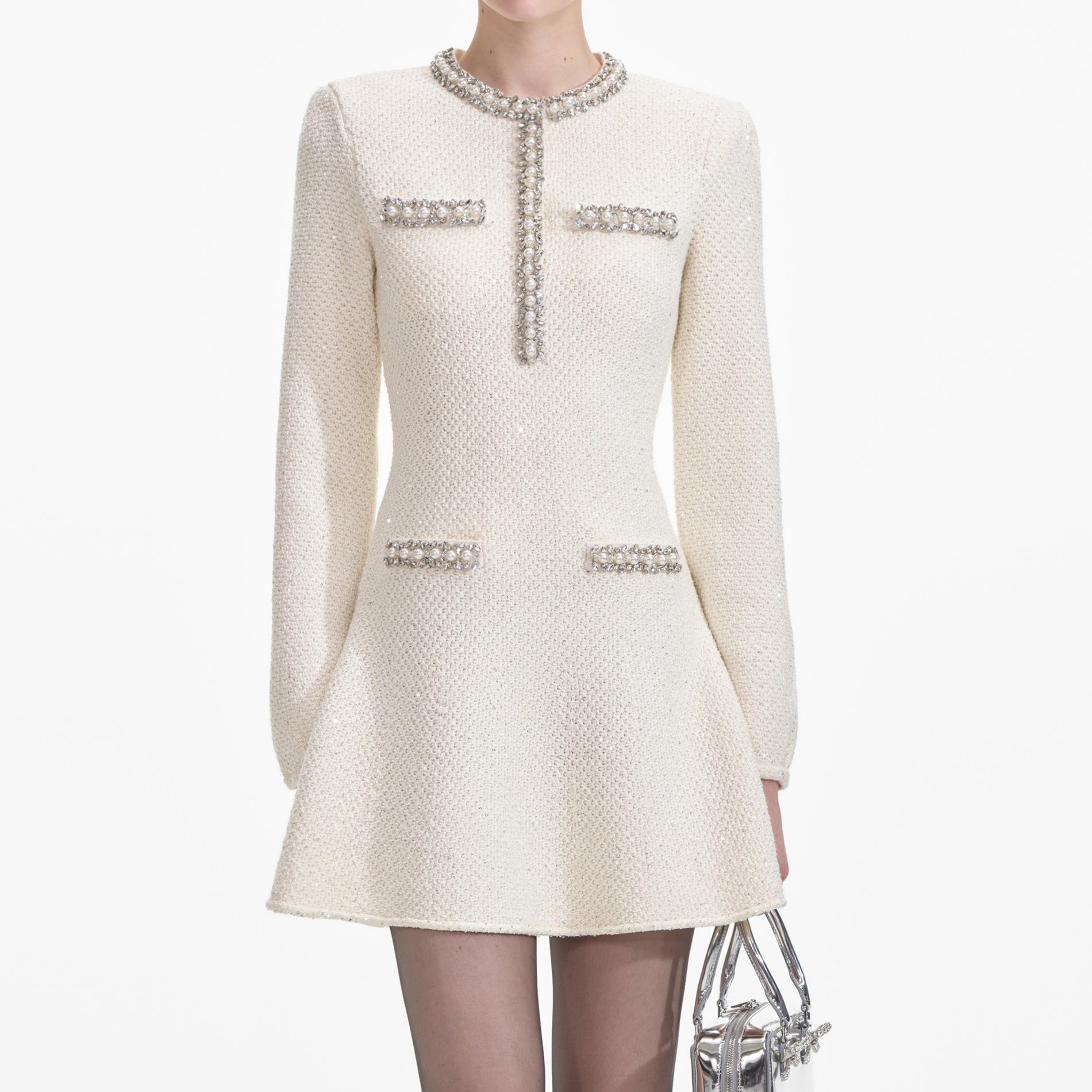 A close up of a woman wearing the Cream Textured Knit Embellished Mini Dress