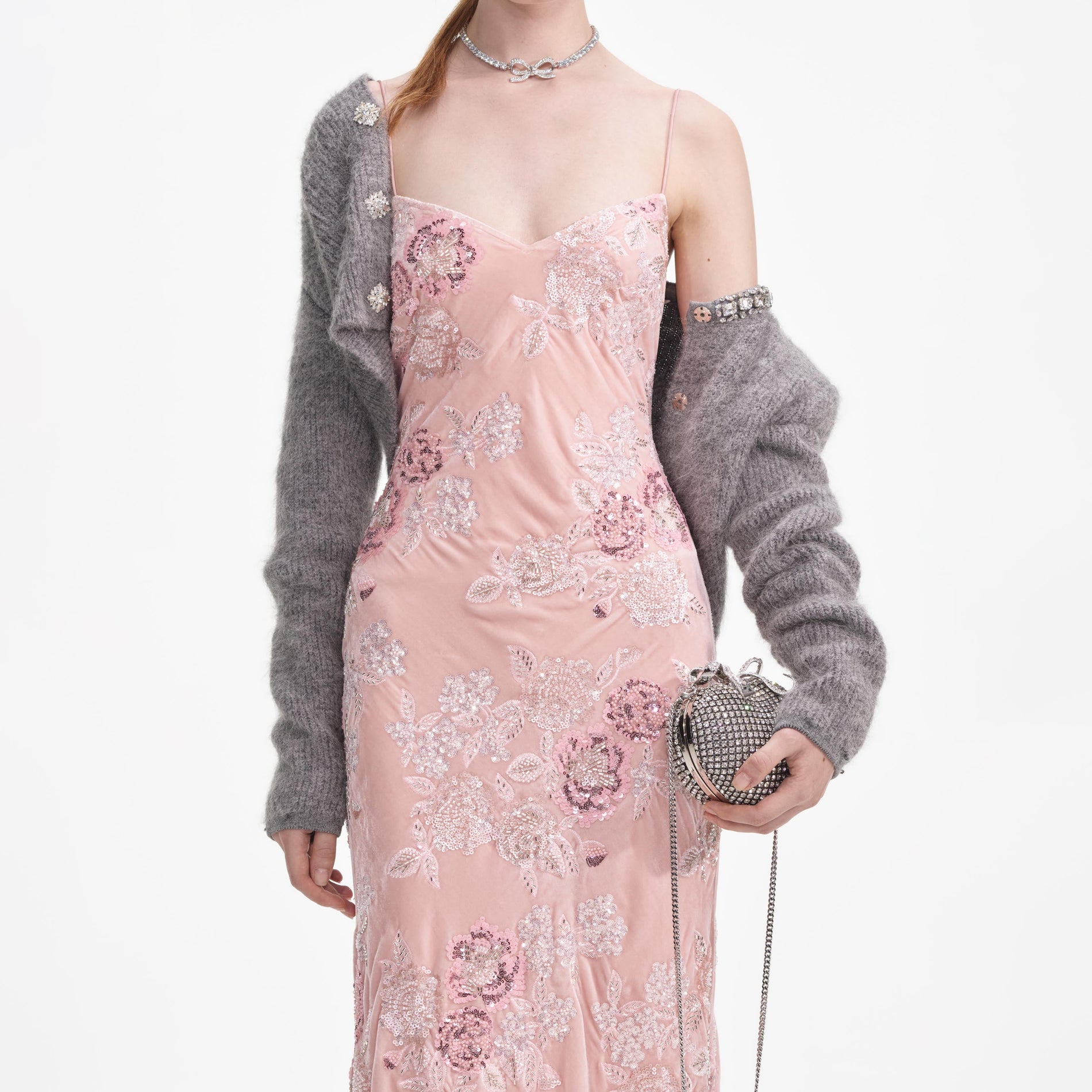 A close up of a woman wearing the Pink Embellished Velvet Maxi Dress