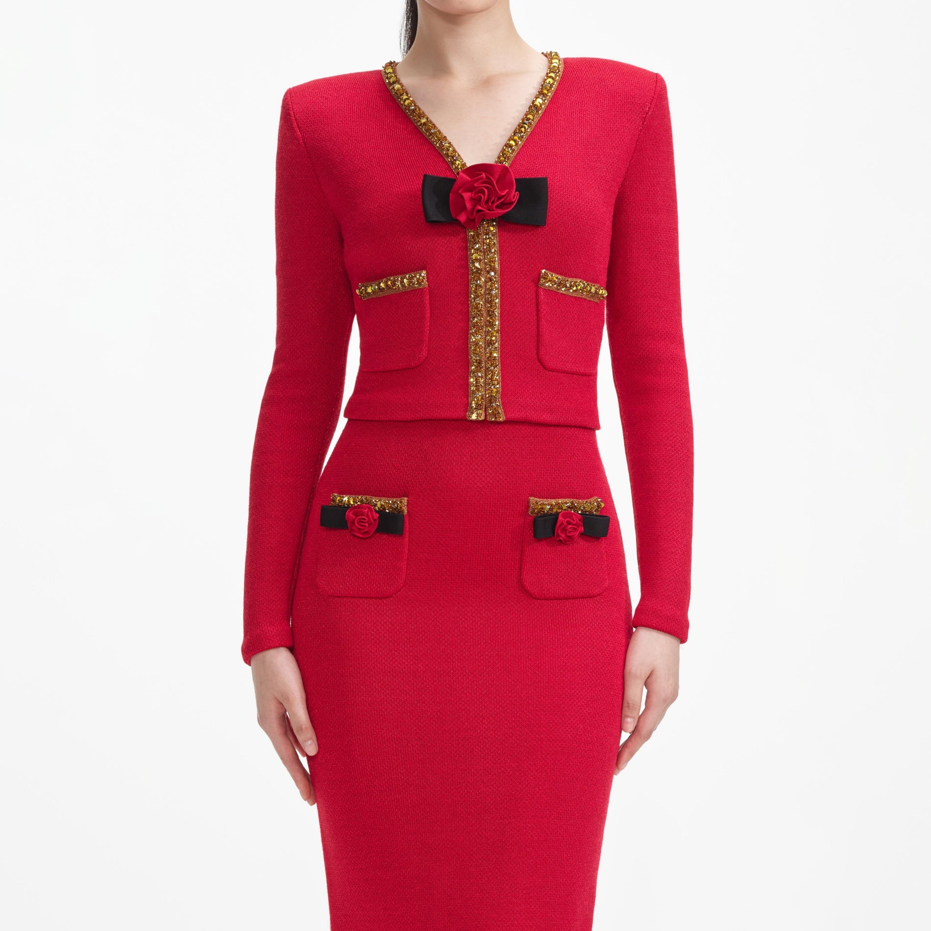 A close up of a woman wearing the Red Textured Knit Corsage Cardigan