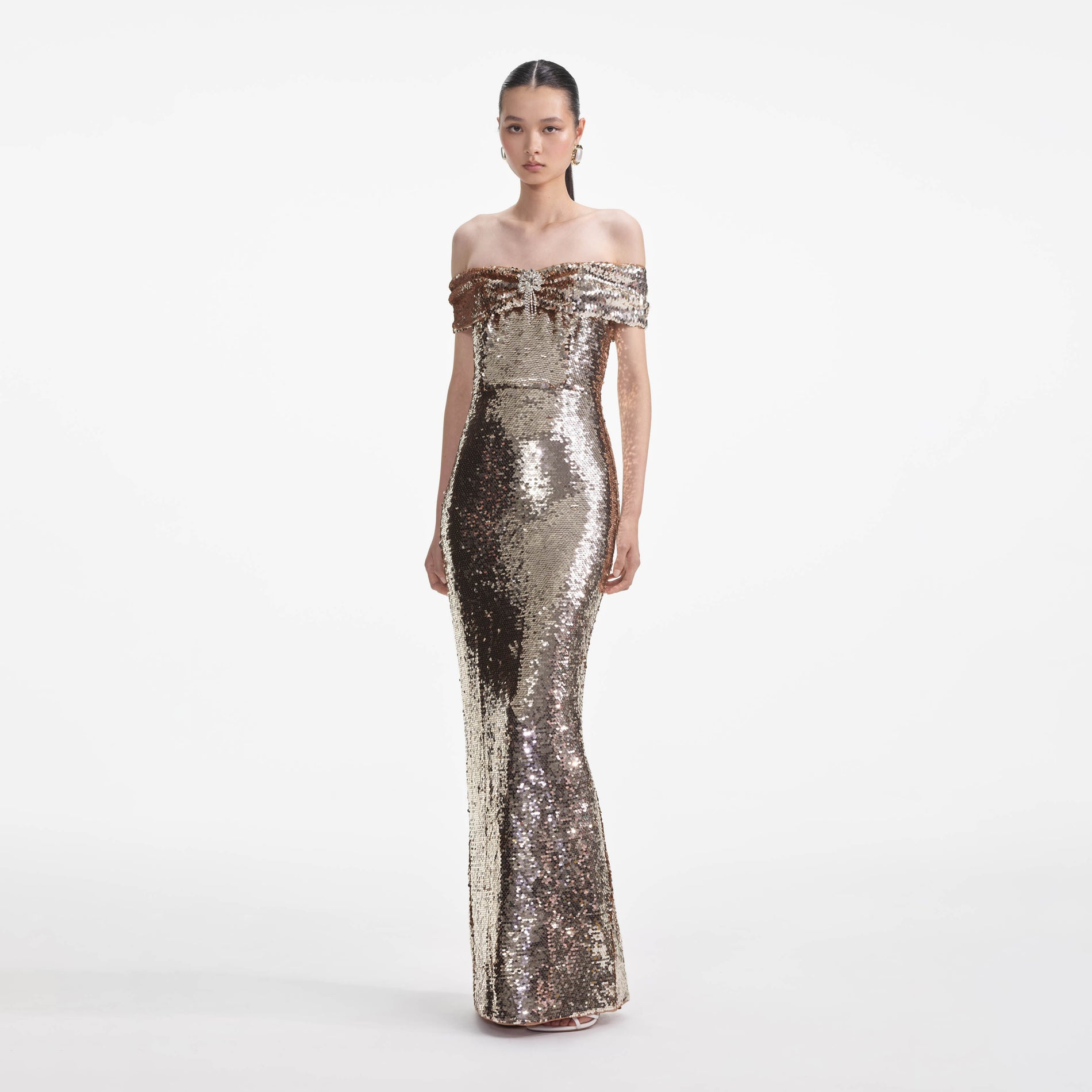Side view of a woman wearing the Gold Sequin Maxi Dress