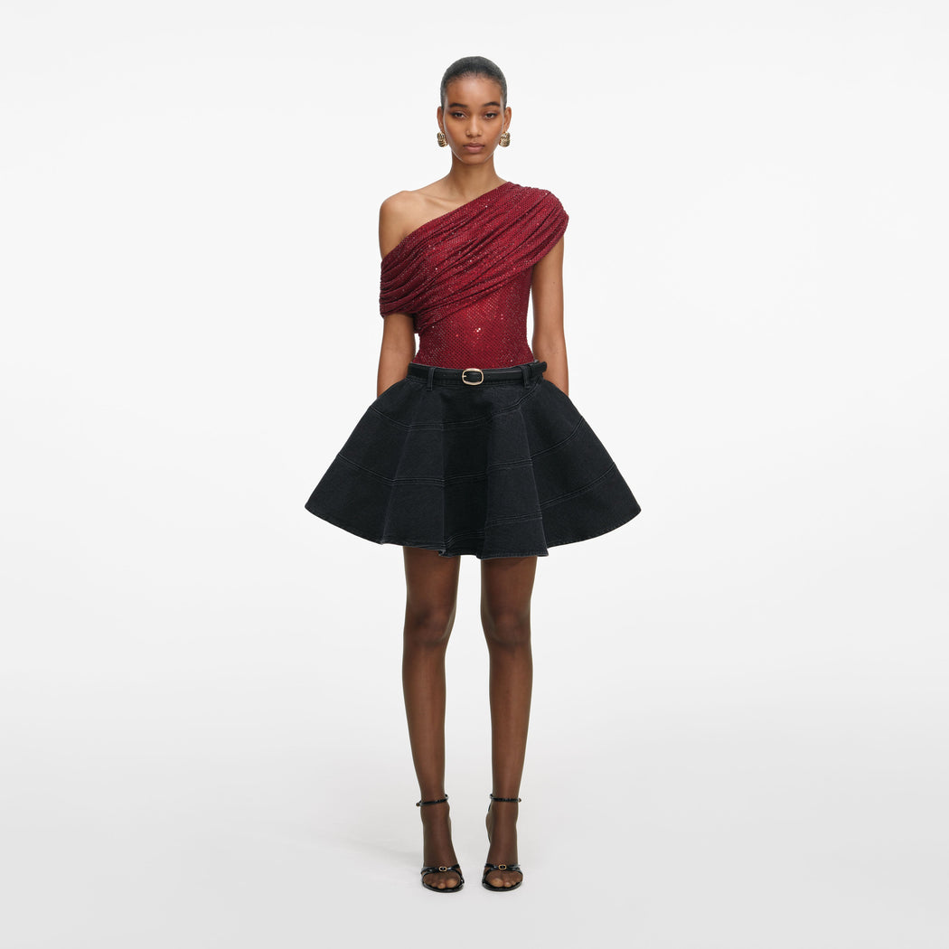 Front view of a woman wearing the Black Flared Denim Mini Skirt