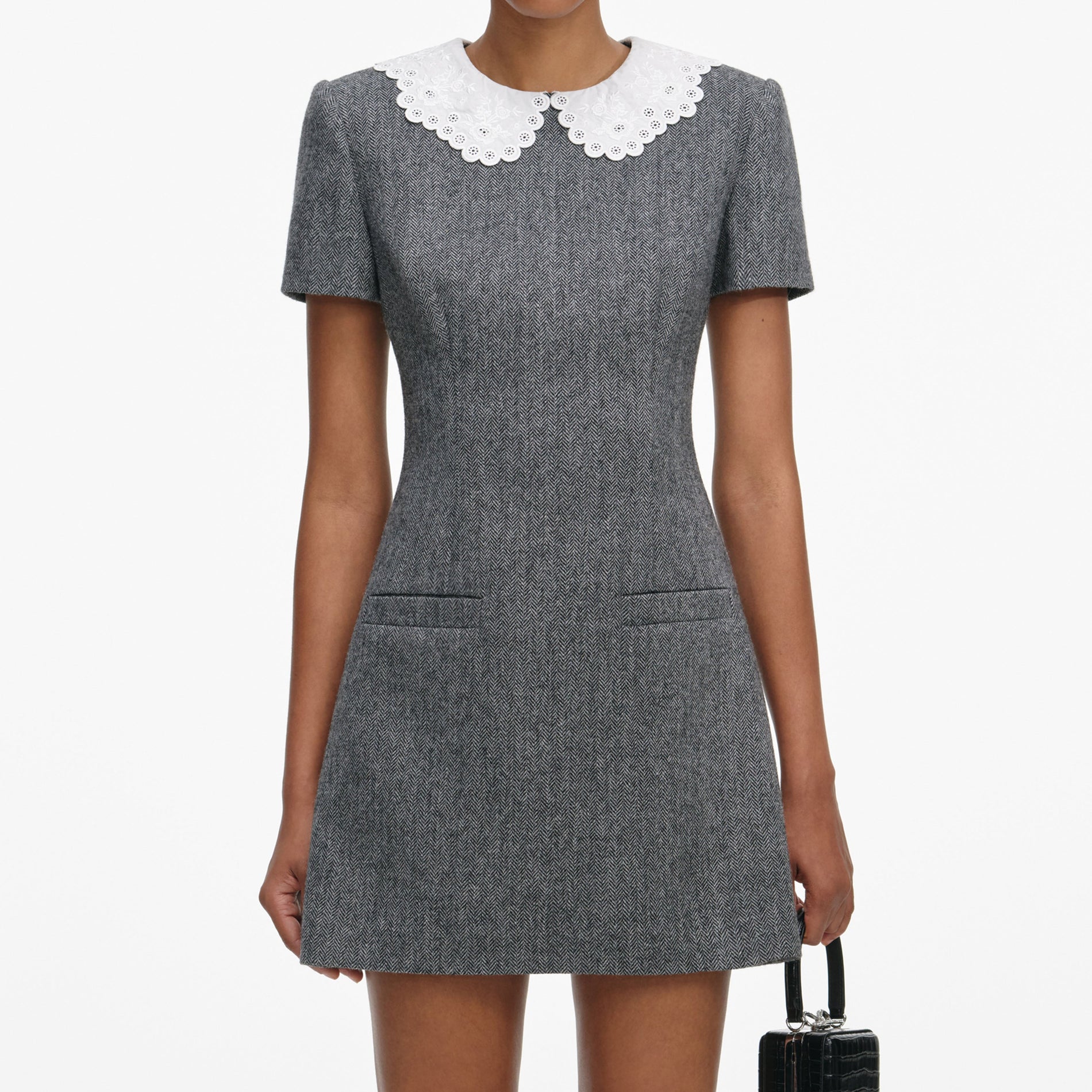 A close up of a woman wearing the Grey Herringbone Collared Mini Dress