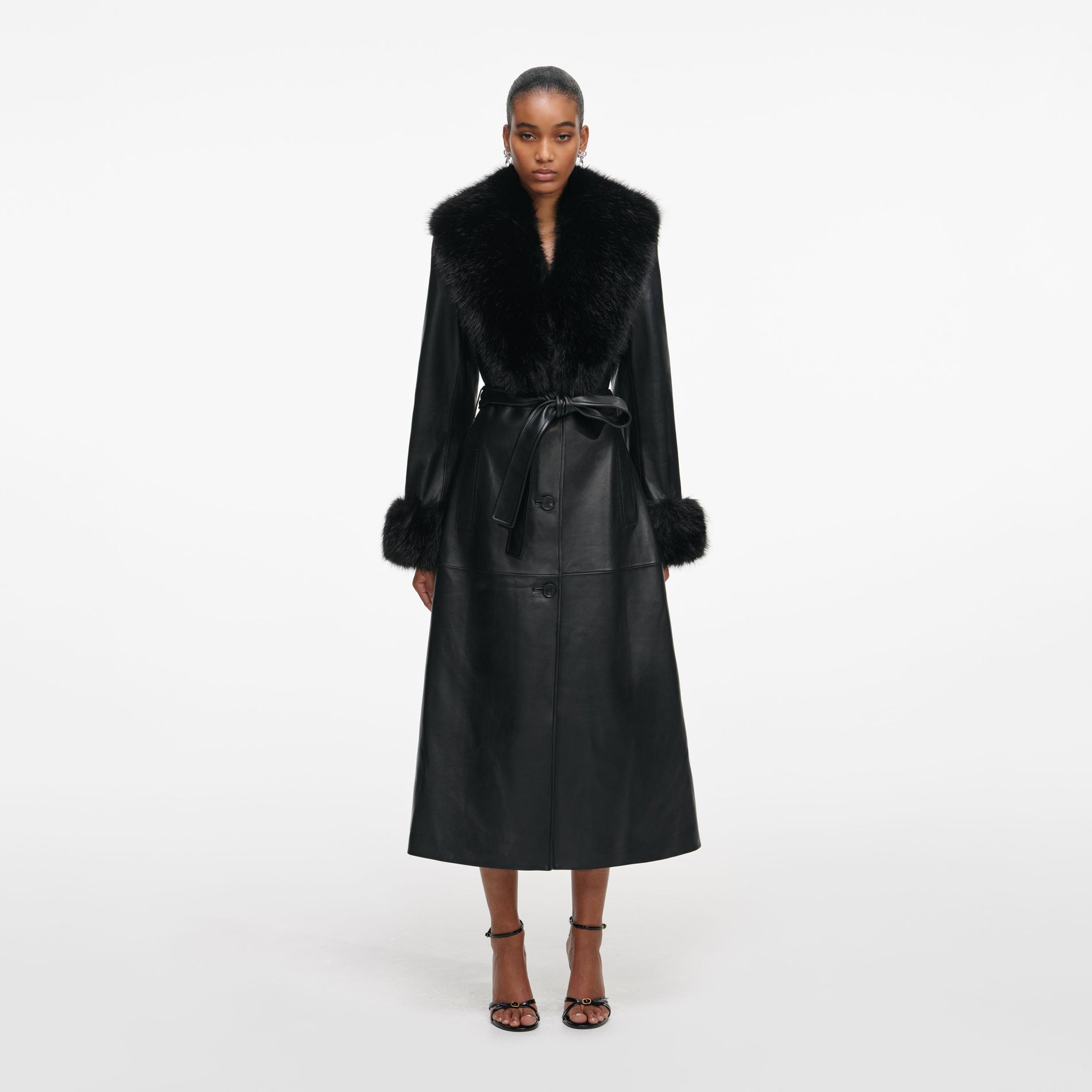Front view of a woman wearing the Black Leather Faux Fur Collared Coat