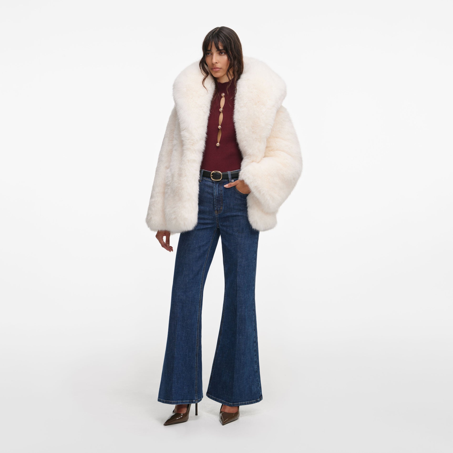 Side view of a woman wearing the White Faux Fur Coat