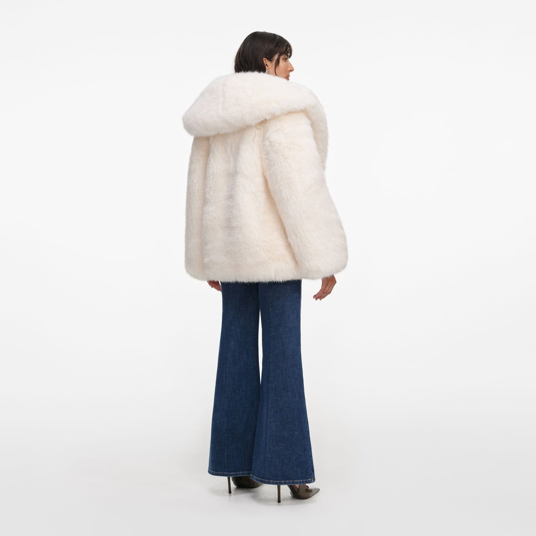 Back view of a woman wearing the White Faux Fur Coat