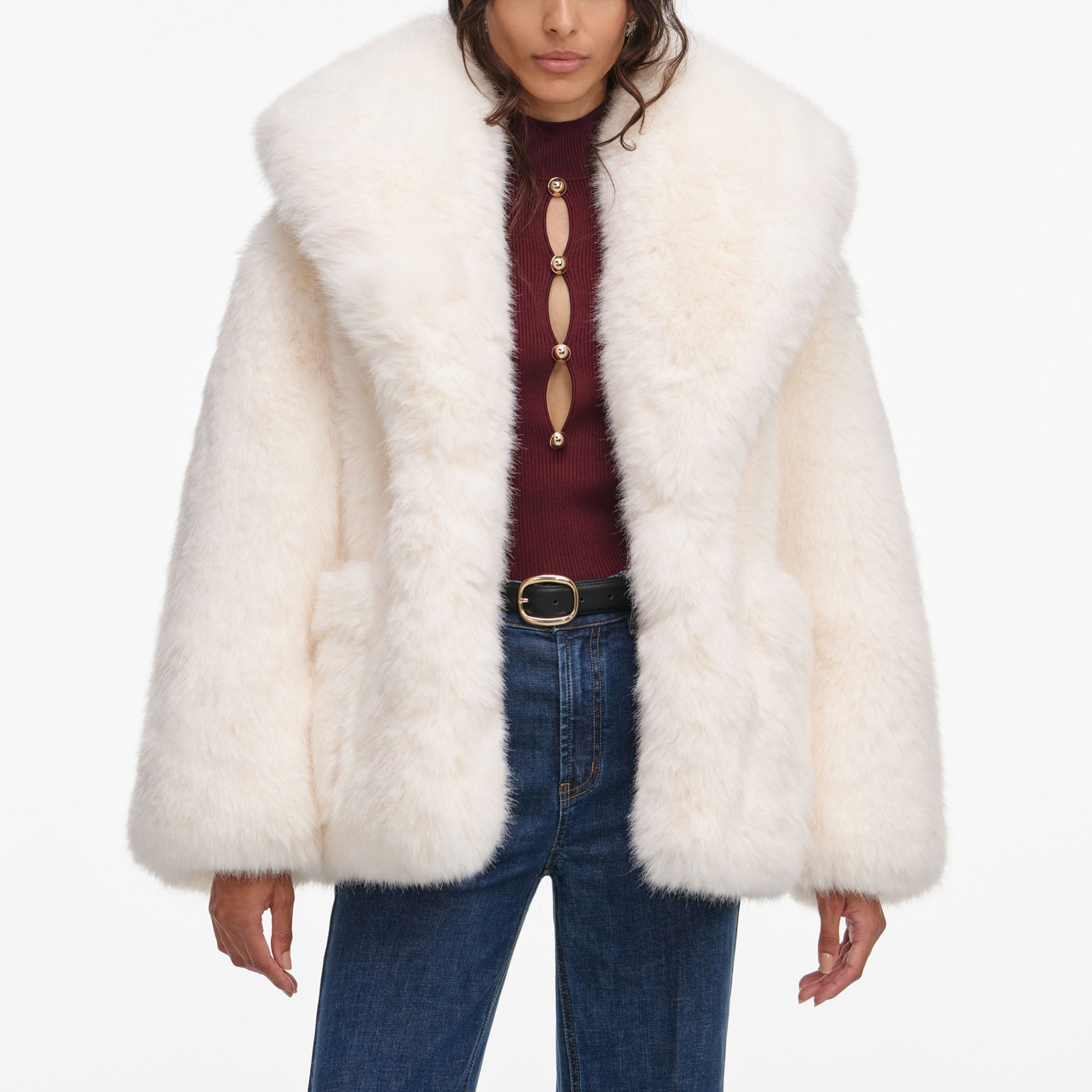 A close up of a woman wearing the White Faux Fur Coat