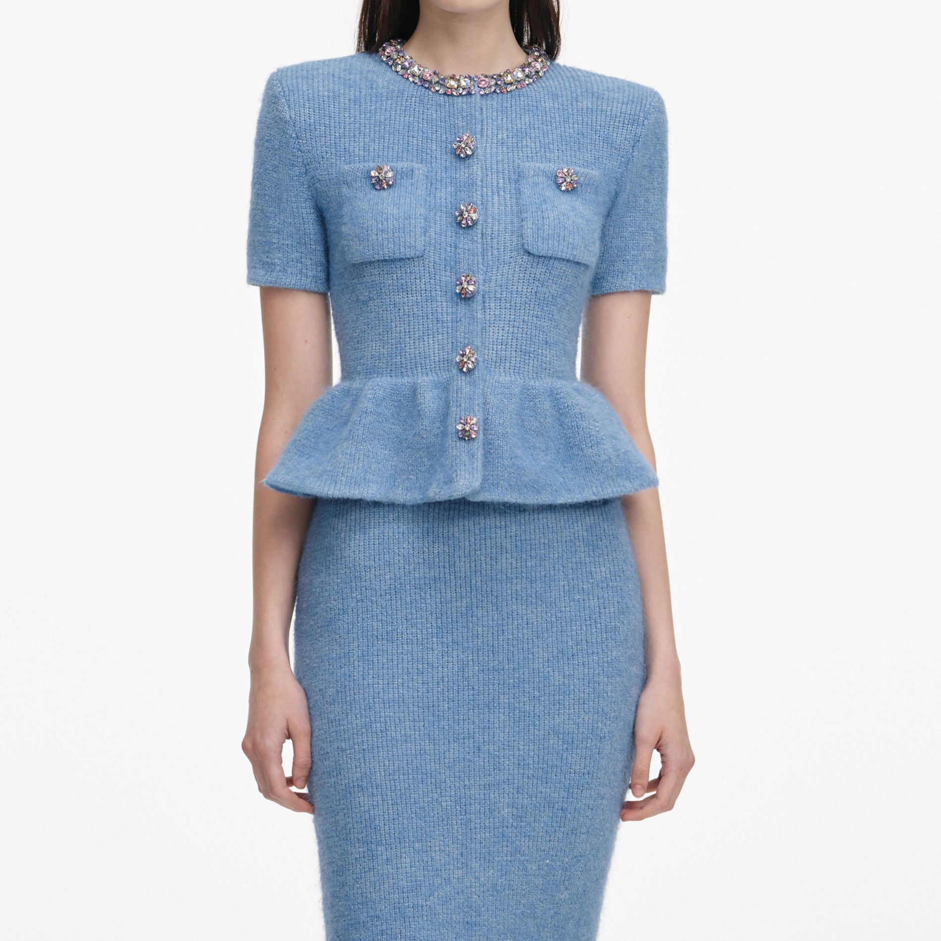 A close up of a woman wearing the Blue Peplum Knit Midi Dress