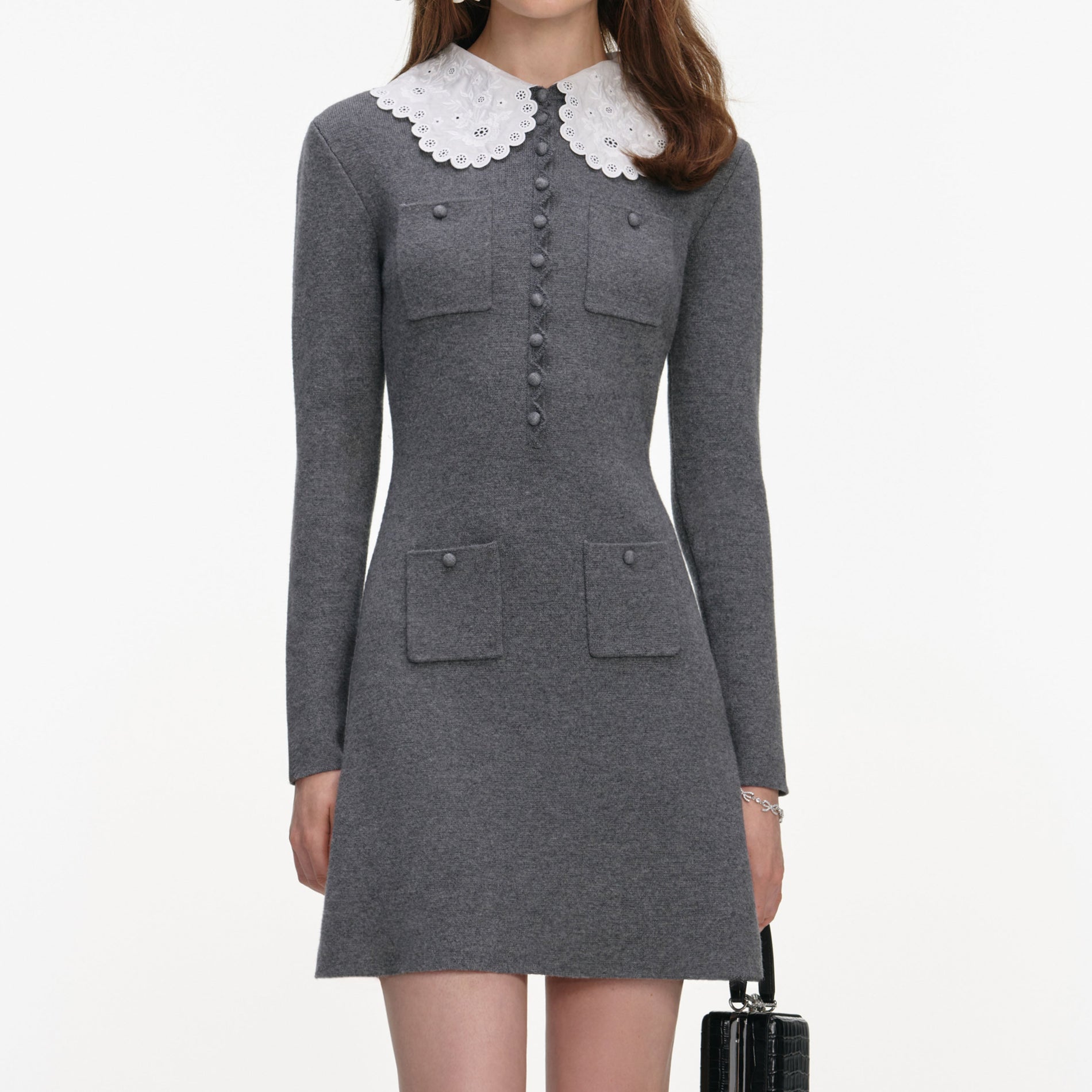 A close up of a woman wearing the Grey Knit Mini Dress