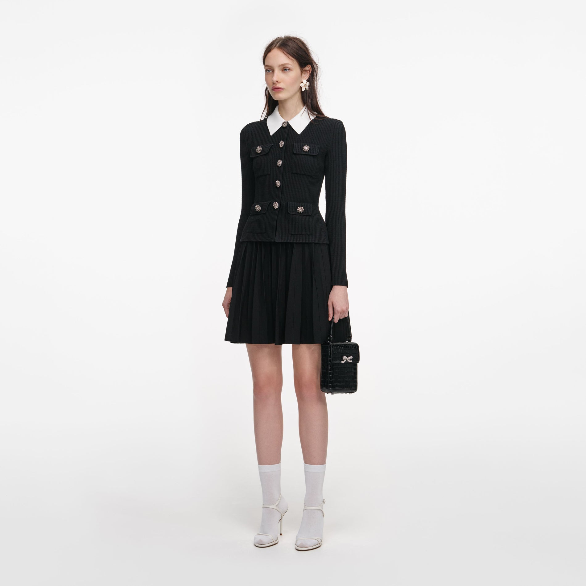 Side view of a woman wearing the Black Tailored Knit Mini Dress