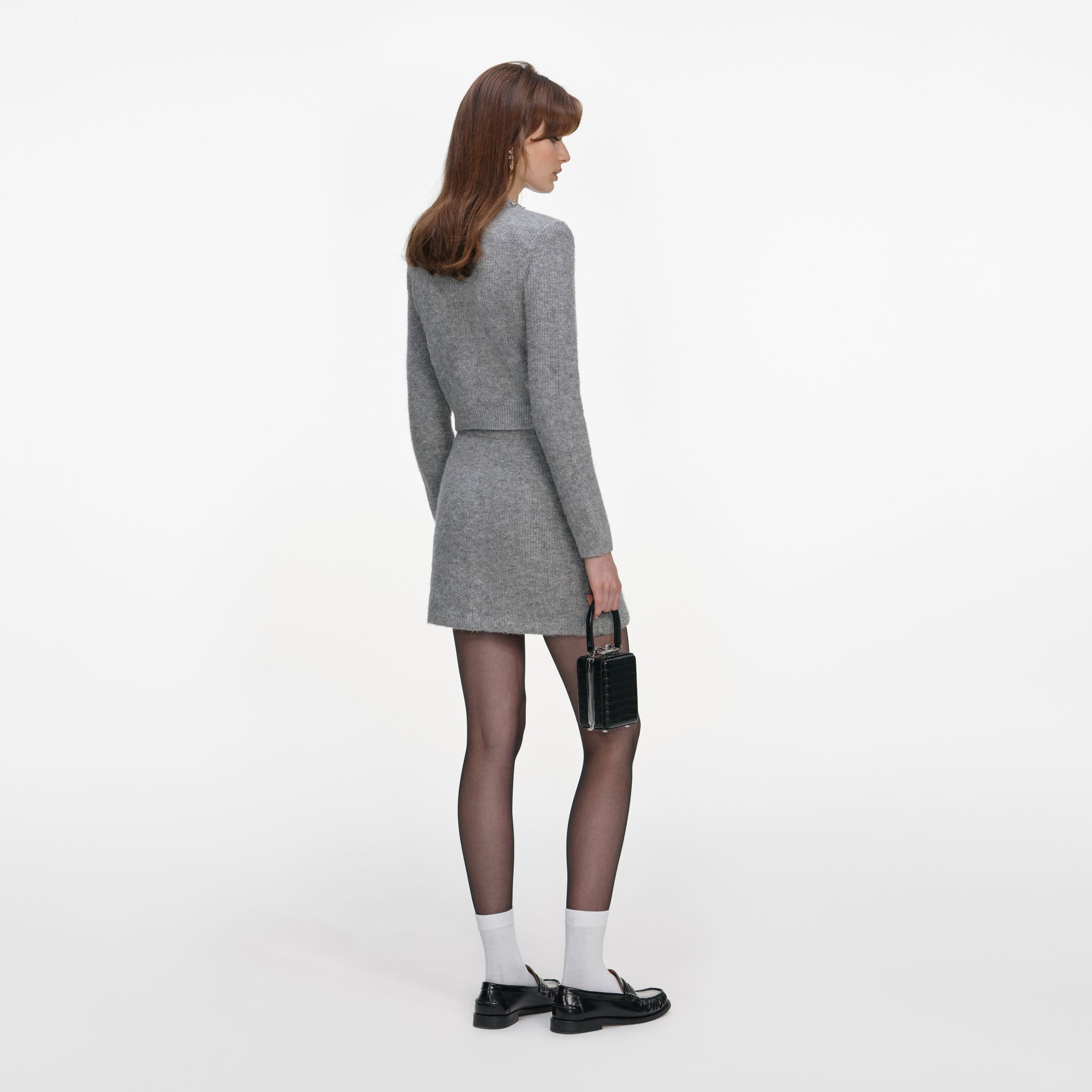 Back view of a woman wearing the Grey Fluffy Knit Mini Skirt
