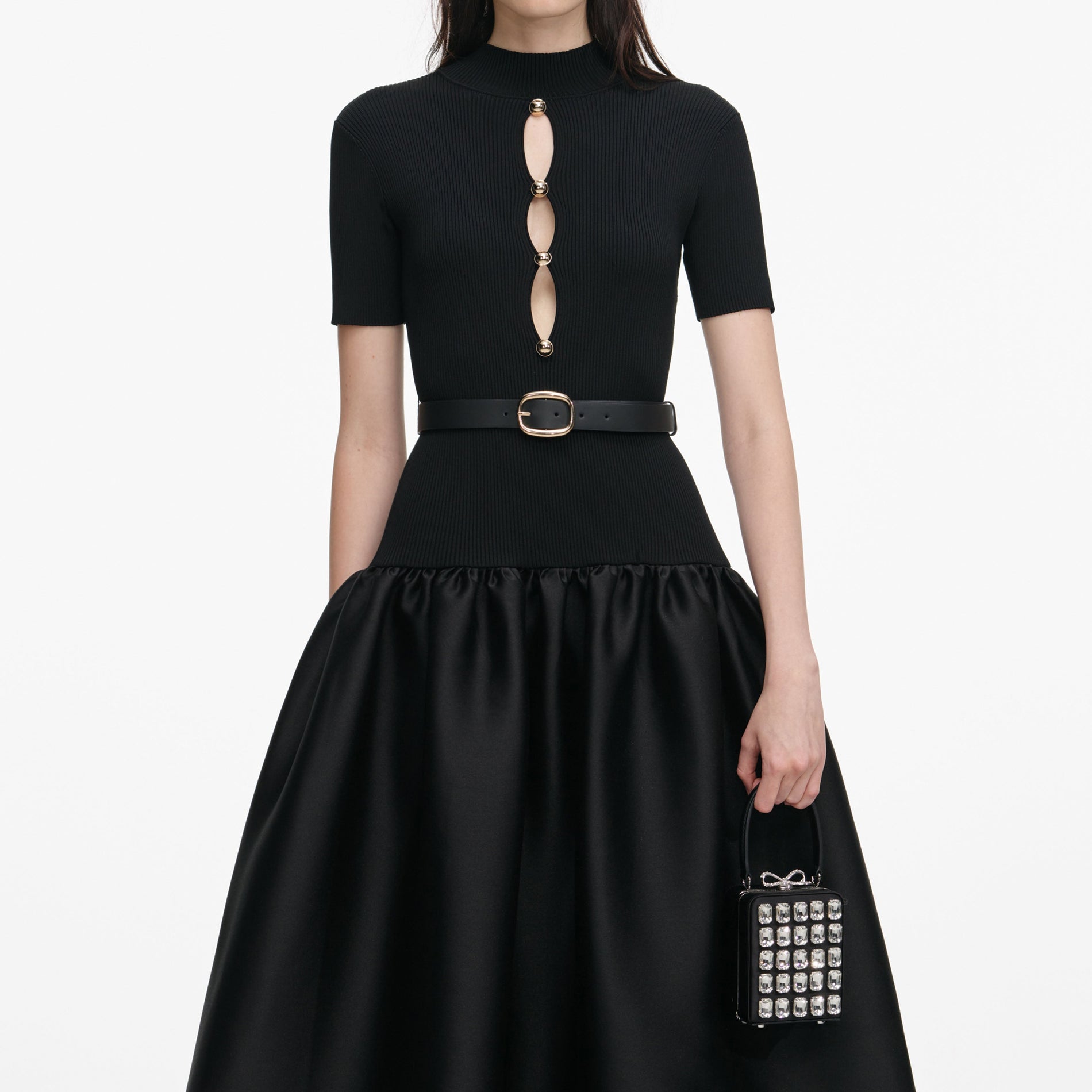 A close up of a woman wearing the Black Knit Taffeta Midi Dress