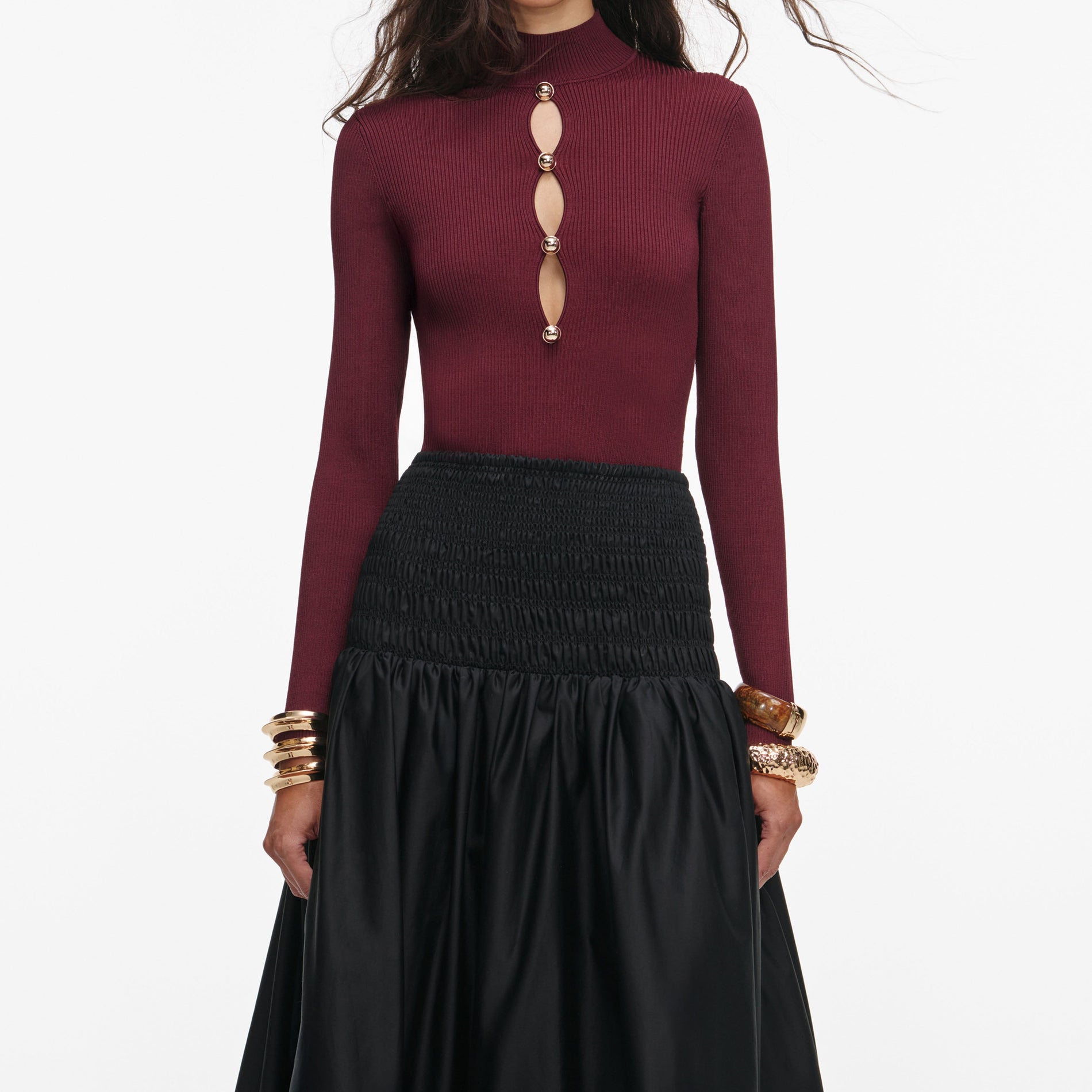 A close up of a woman wearing the Black Cotton Midi Skirt