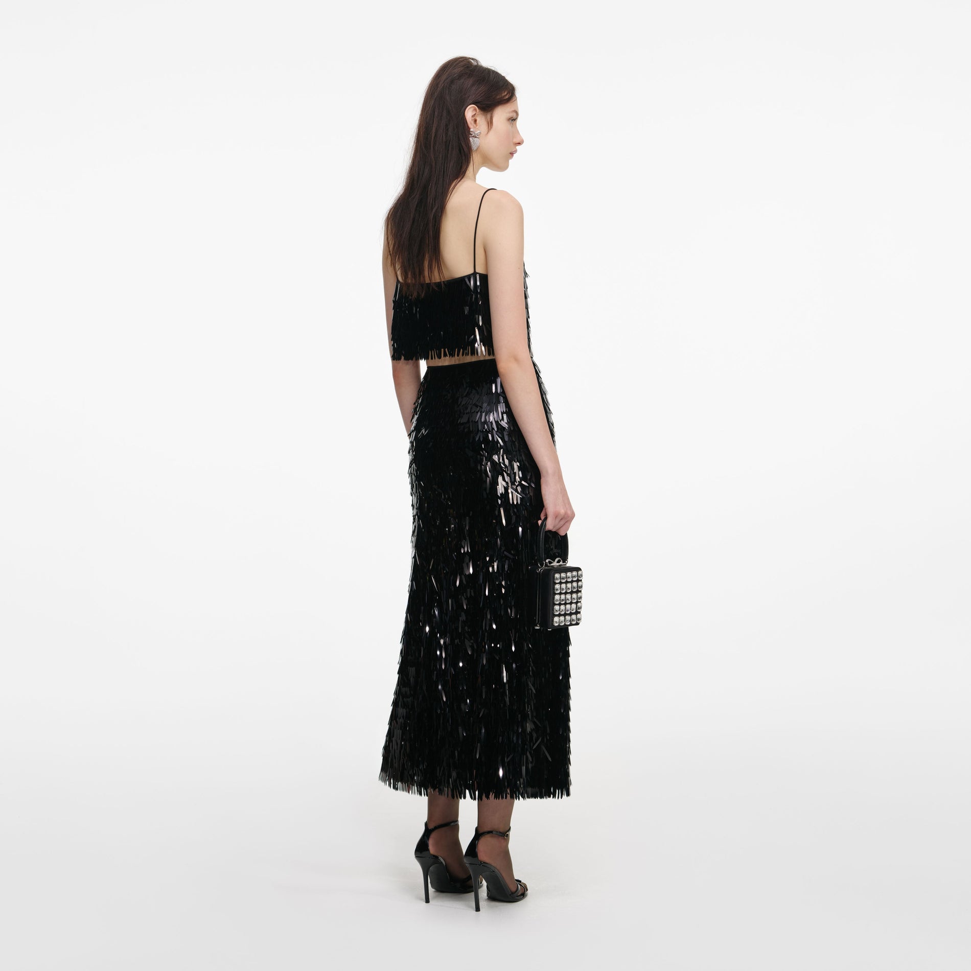 Back view of a woman wearing the Black Sequin Top