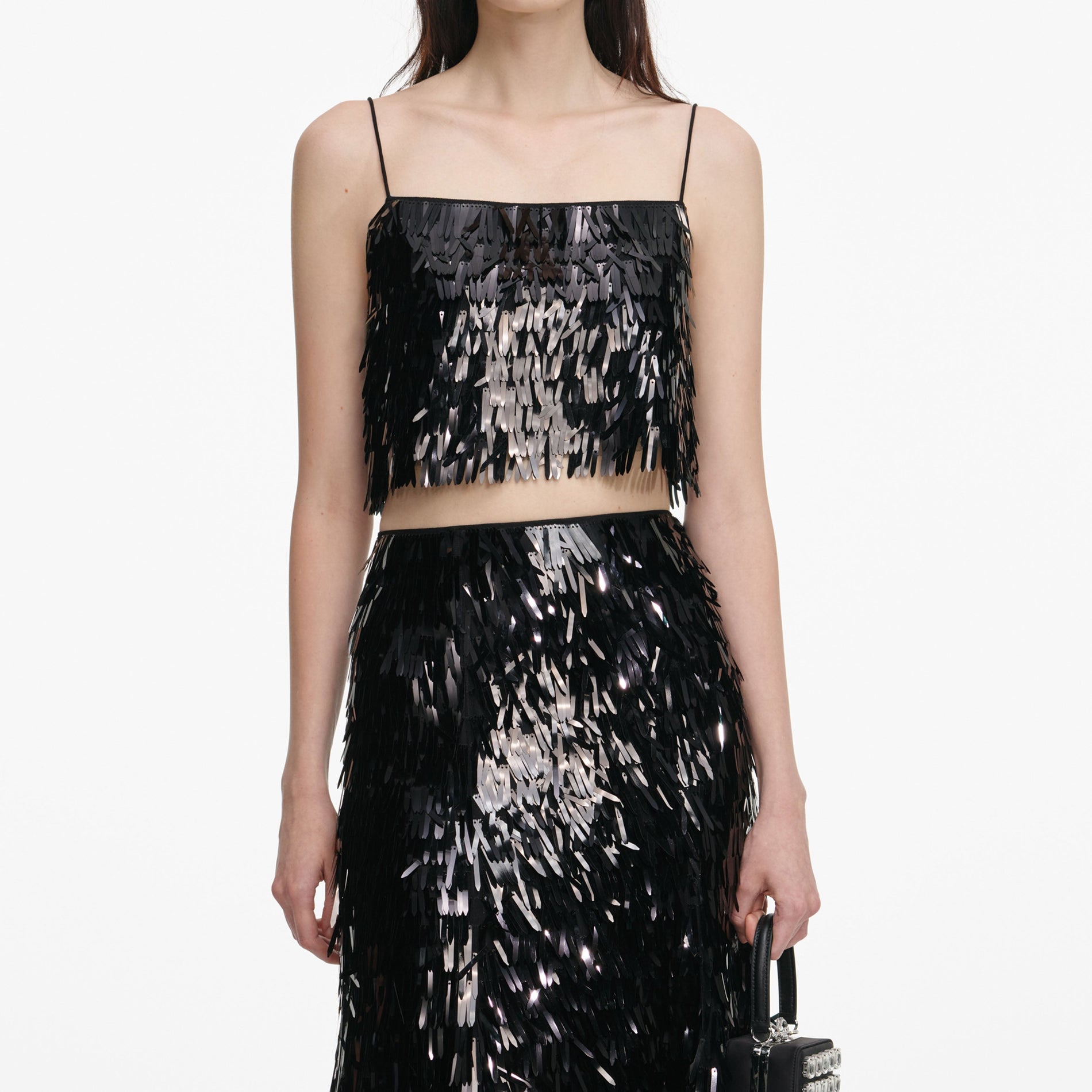 A close up of a woman wearing the Black Sequin Top