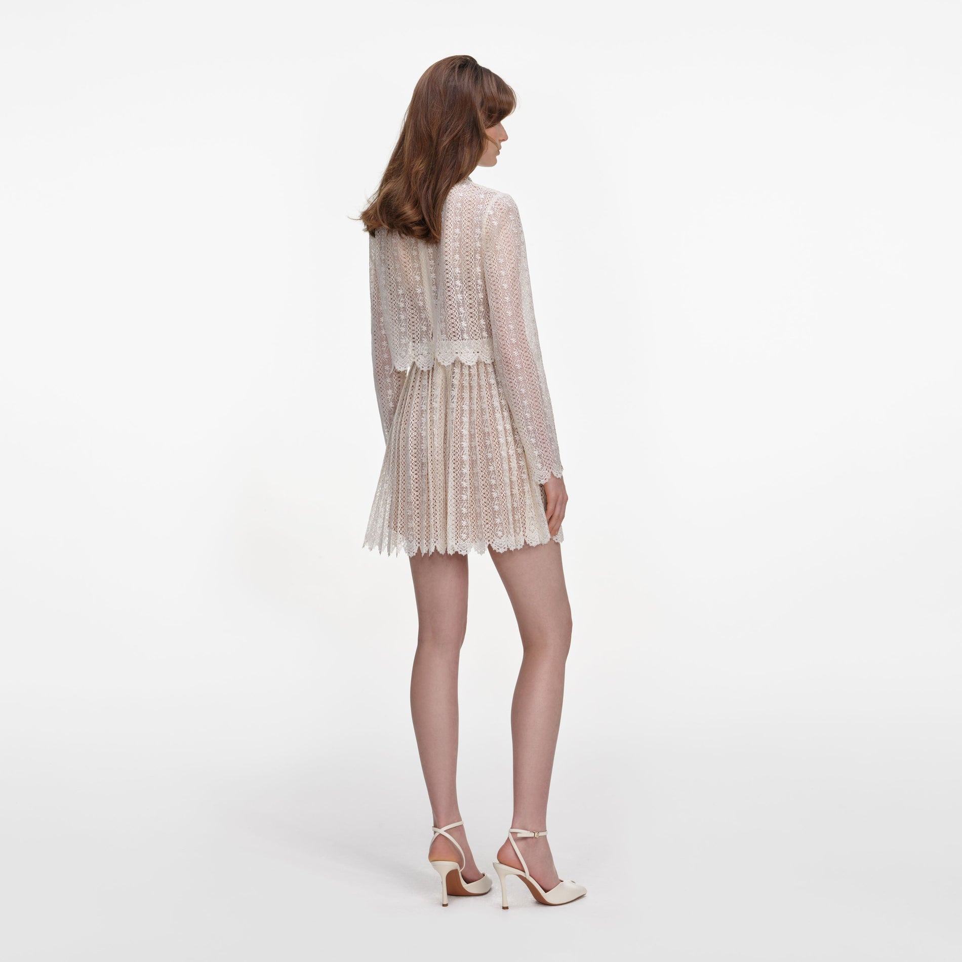 Back view of a woman wearing the Cream Organza Lace Mini Dress