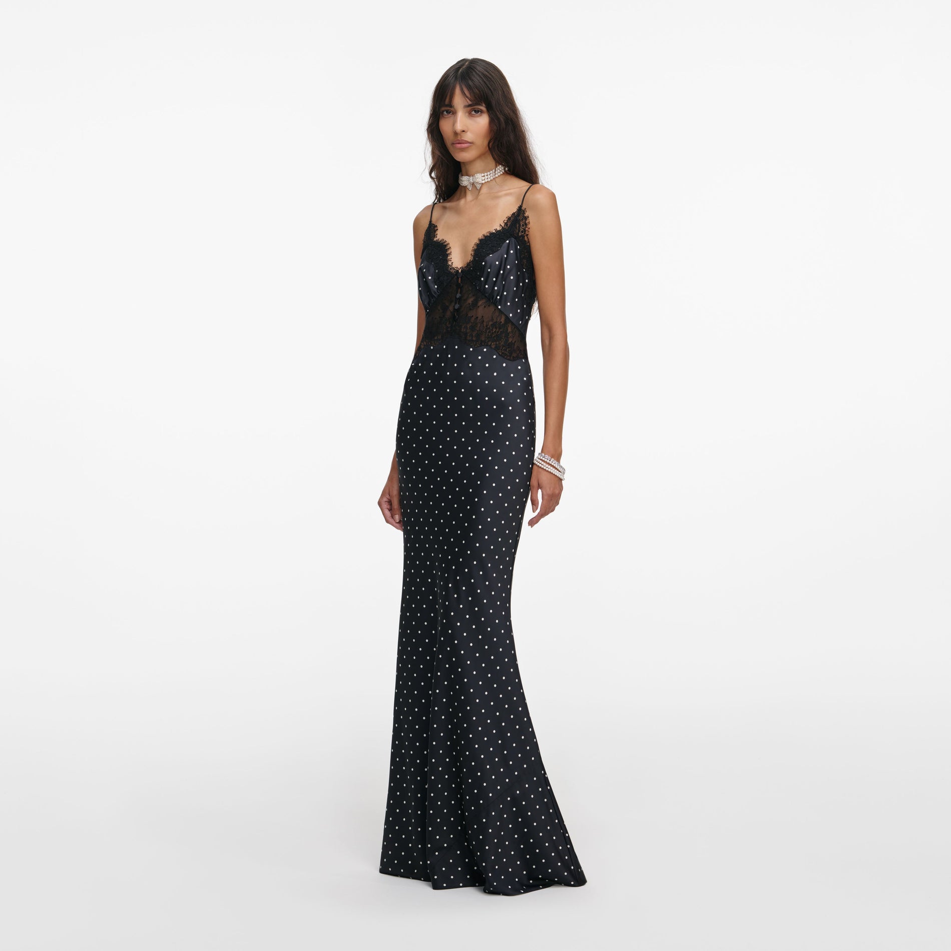Side view of a woman wearing the Polka Dot Satin Lace Maxi Dress