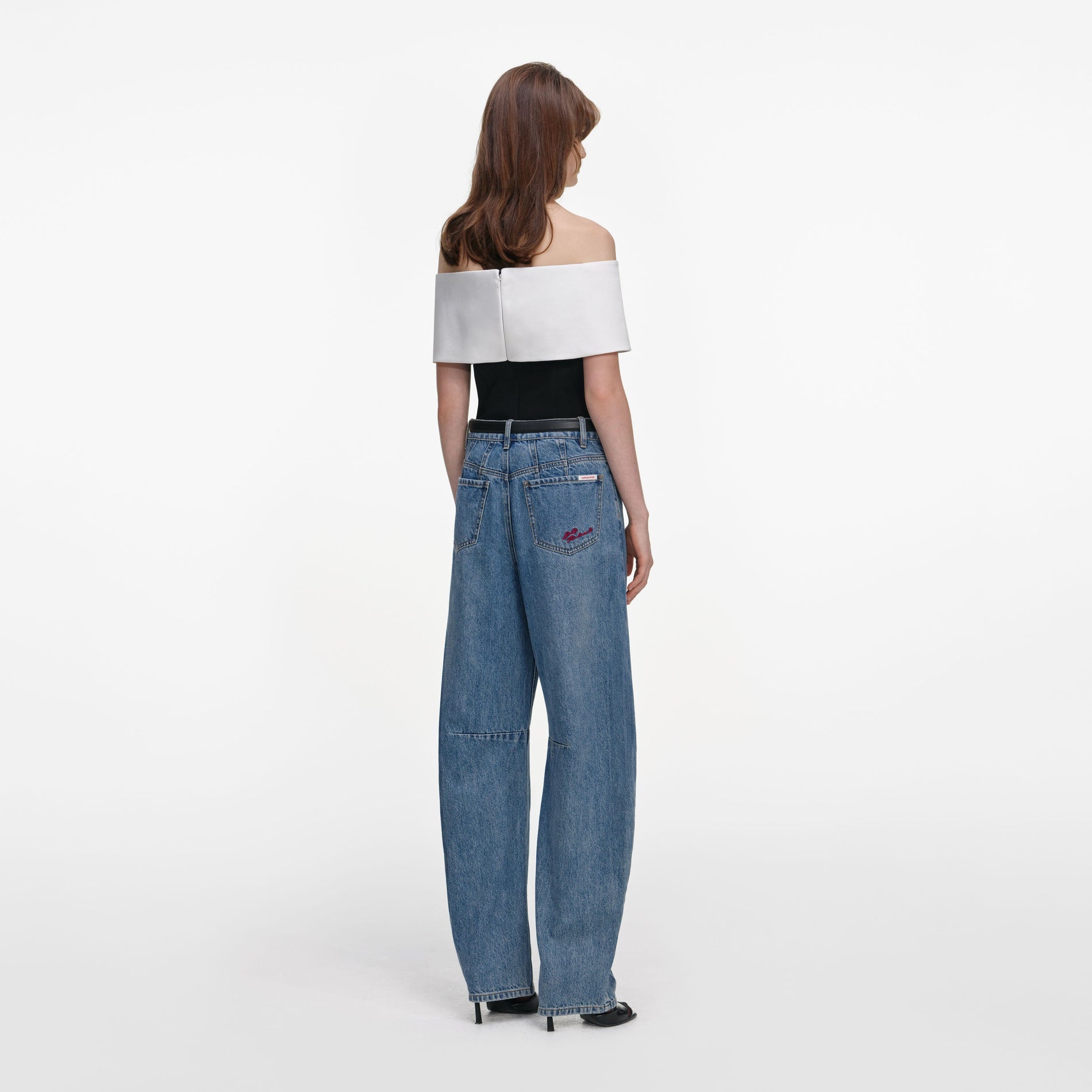 Back view of a woman wearing the Black Crepe Flower Top
