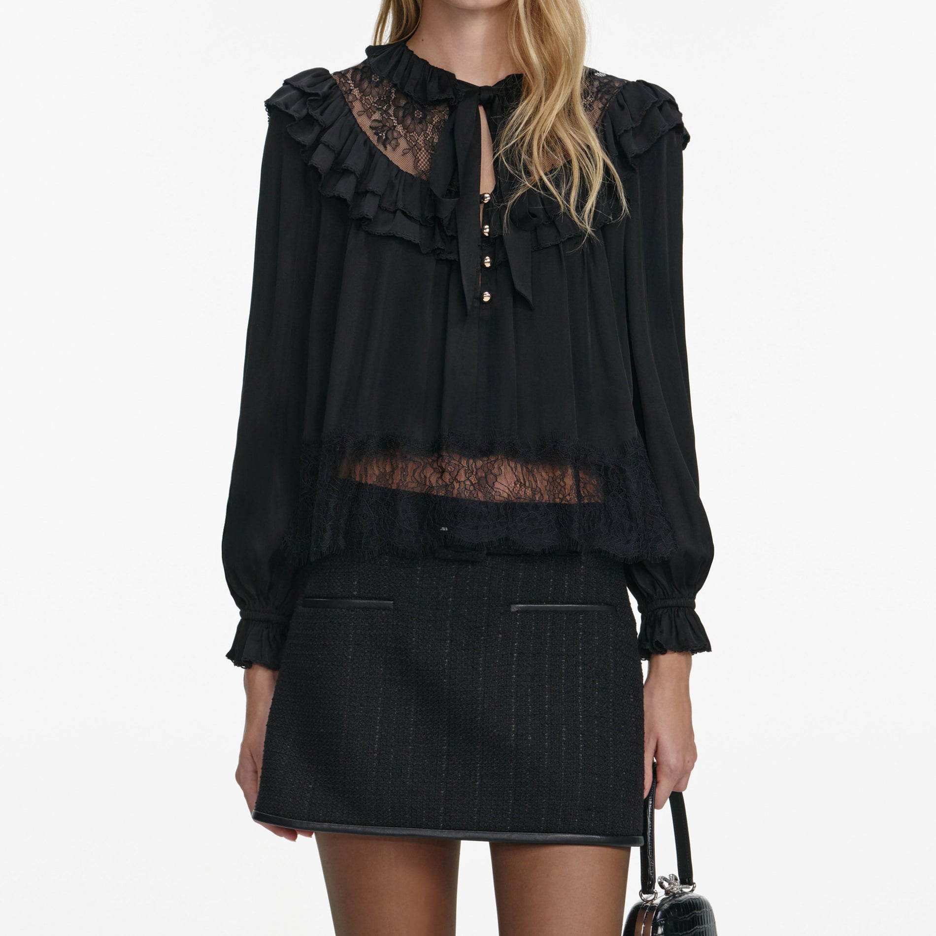A close up of a woman wearing the Black Viscose Lace Blouse