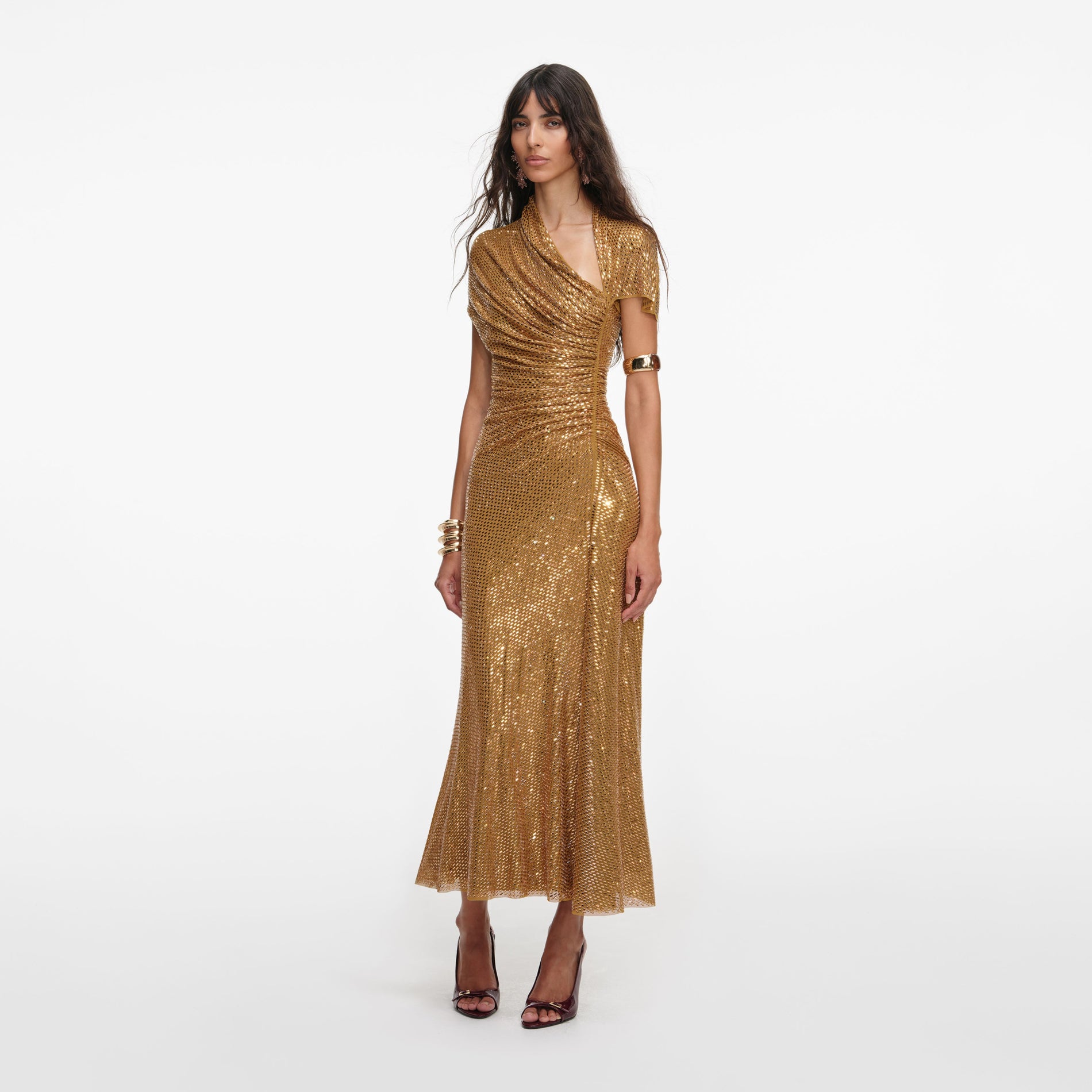 Side view of a woman wearing the Gold Rhinestone Drape Midi Dress