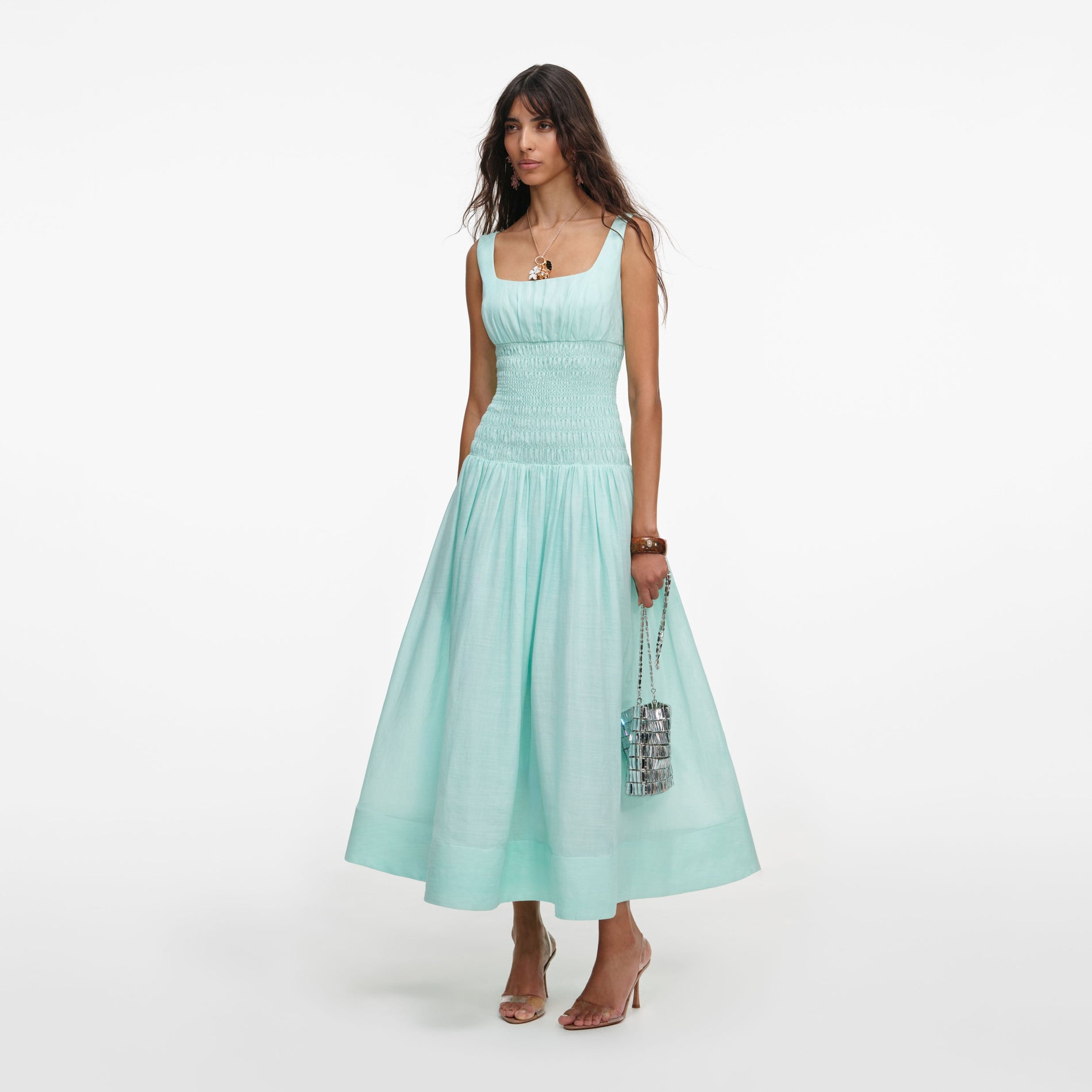 Side view of a woman wearing the Mint Ramie Midi Dress