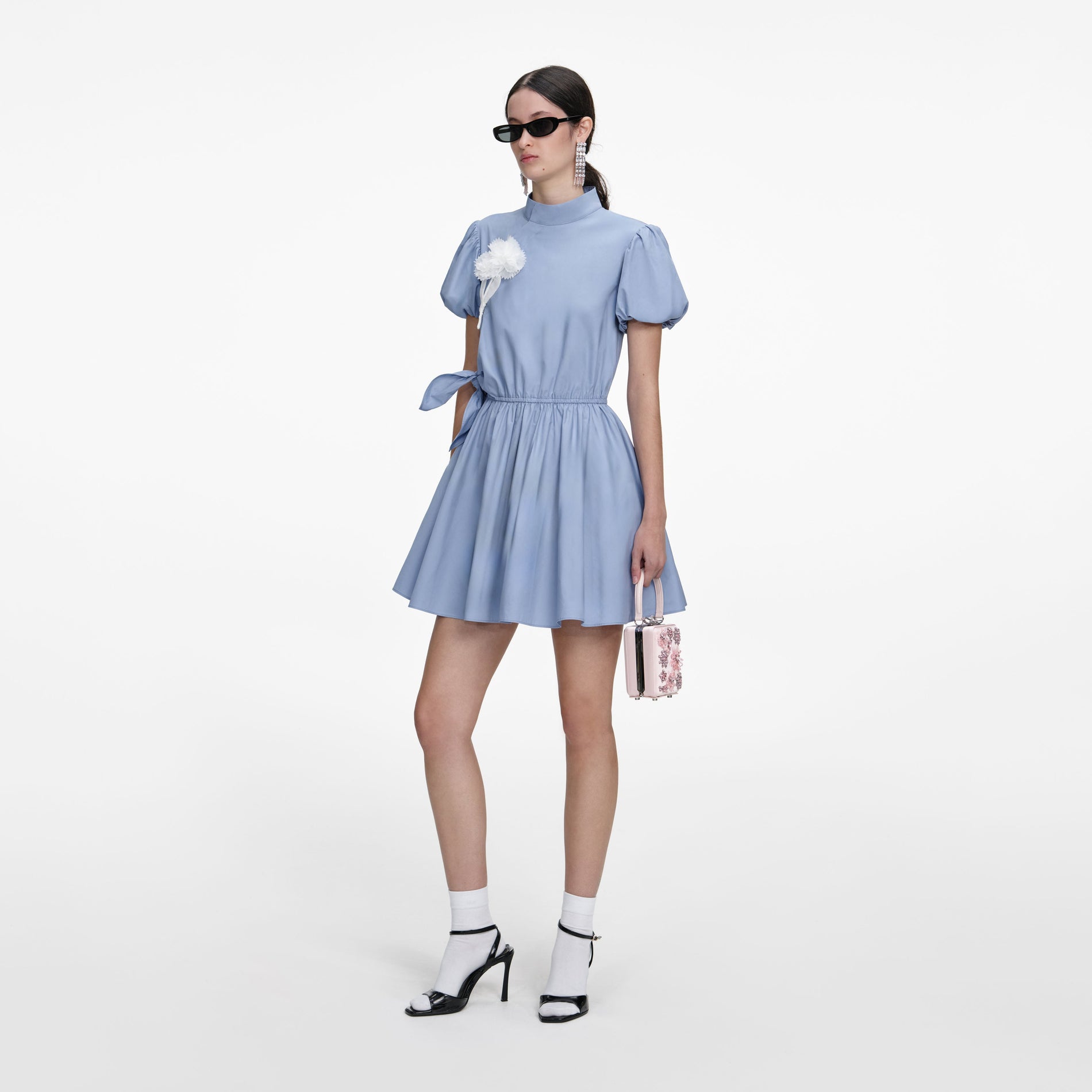 Side view of a woman wearing the Blue Cotton Drape Mini Dress