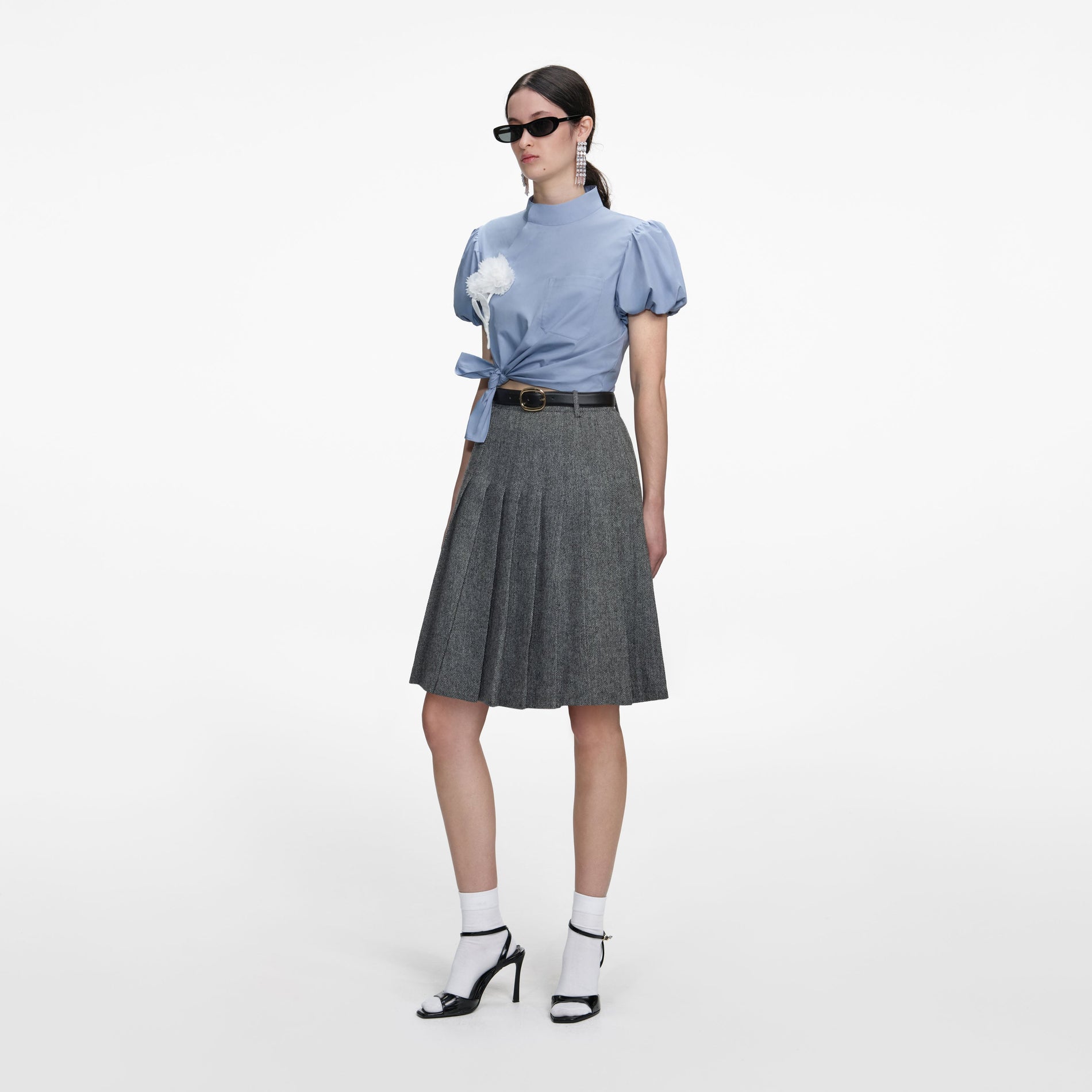 Side view of a woman wearing the Blue Cotton Tie Side Top