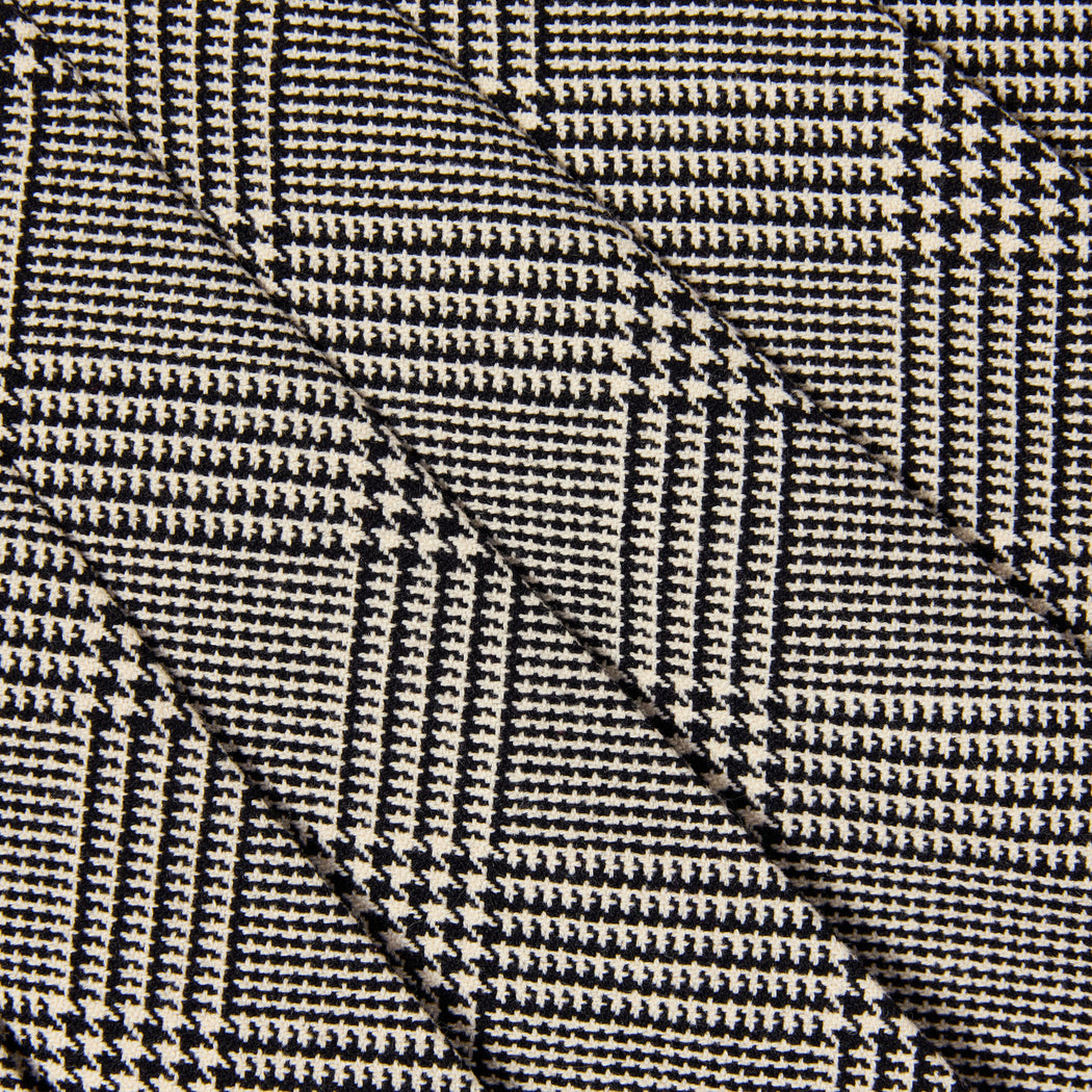 Black and white houndstooth fabric with diagonal folds