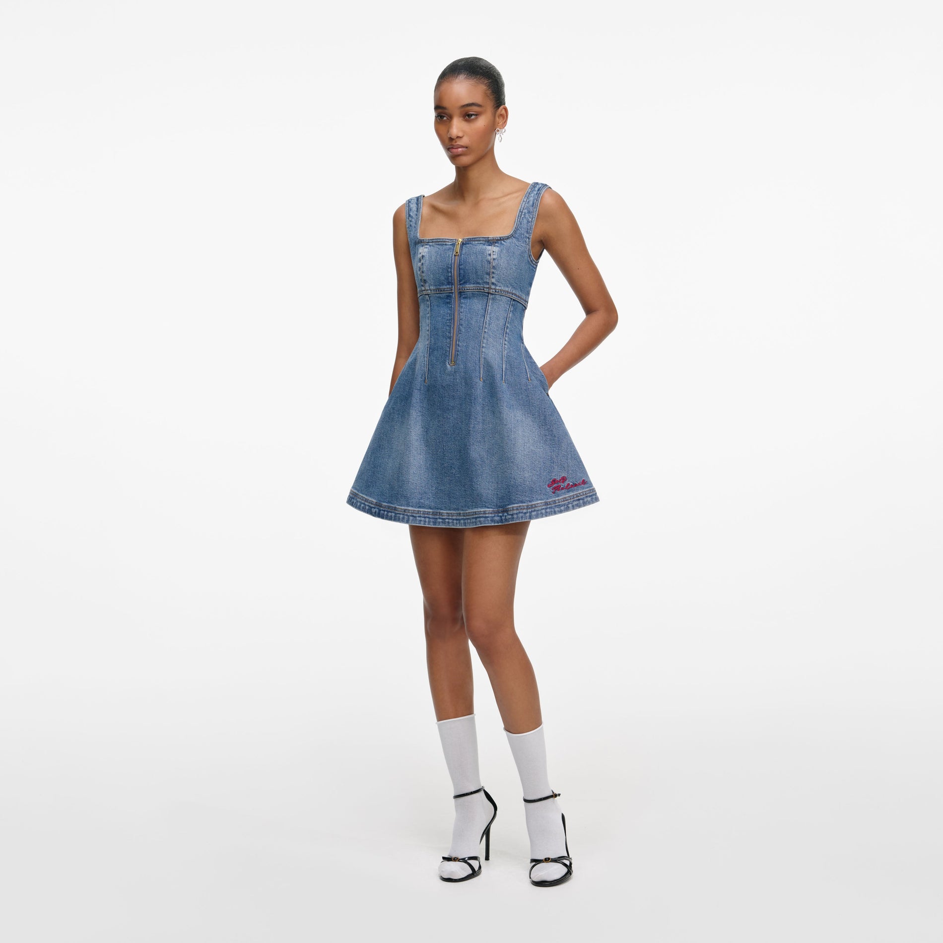Side view of a woman wearing the Denim Mini Dress