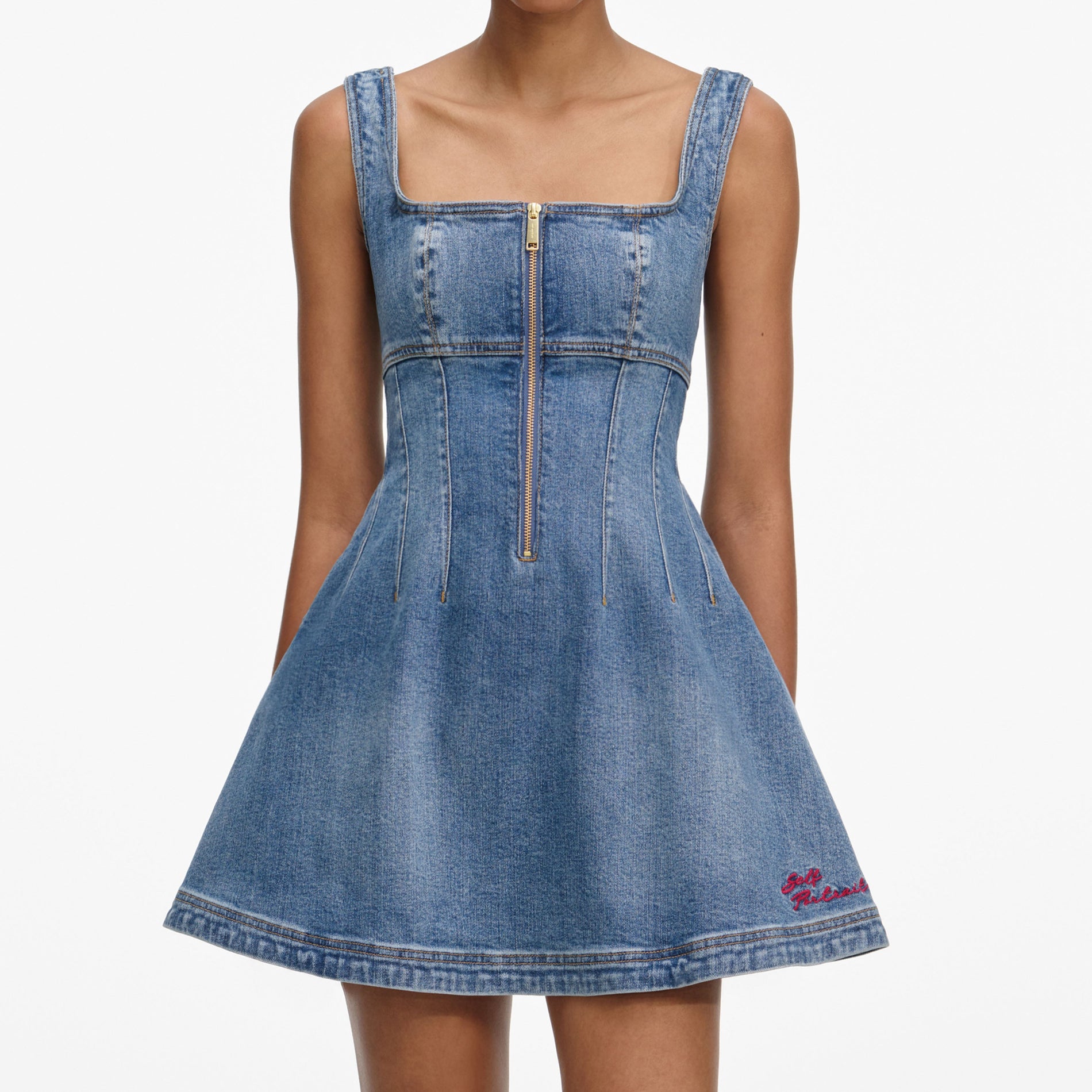 A close up of a woman wearing the Denim Mini Dress
