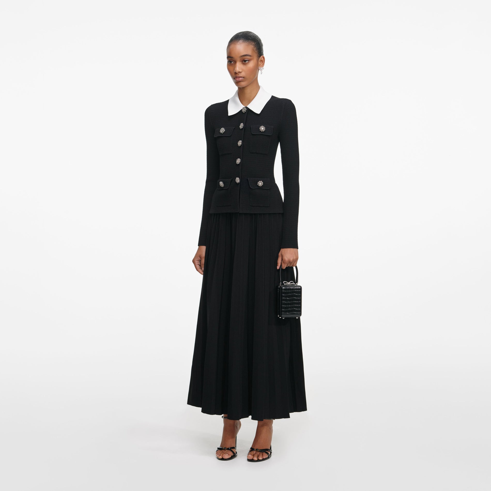 Side view of a woman wearing the Black Tailored Knit Midi Dress
