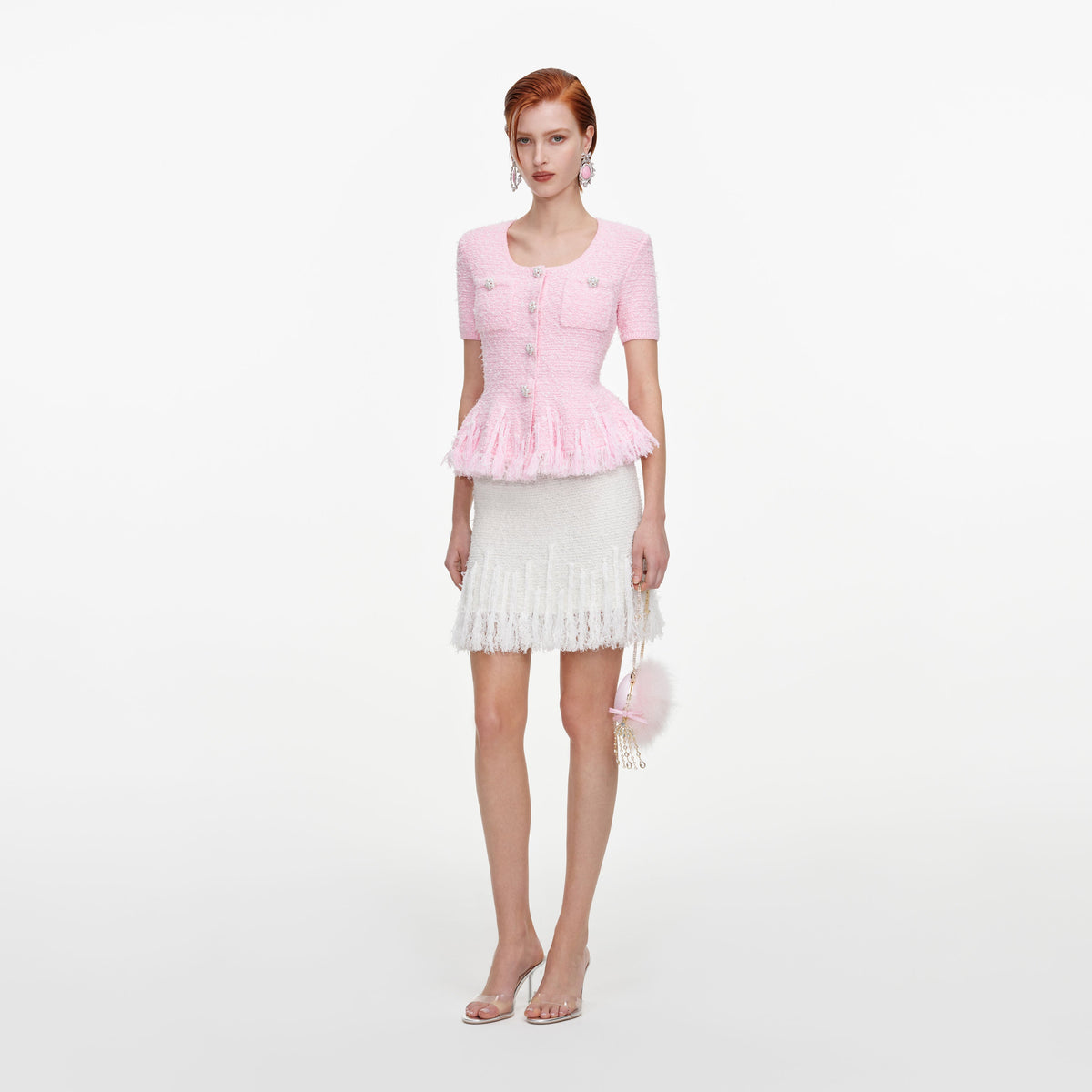 Side view of a woman wearing the Pink Textured Fringe Knit Top
